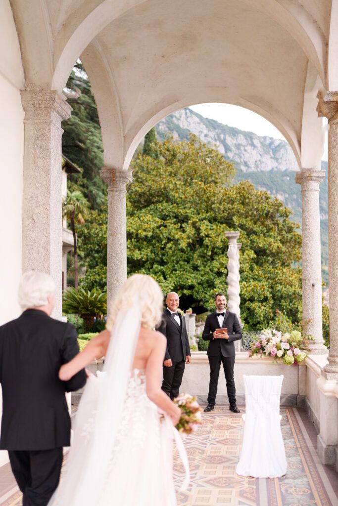 Wedding ceremony moments captured in a classical Italian villa colonnade.