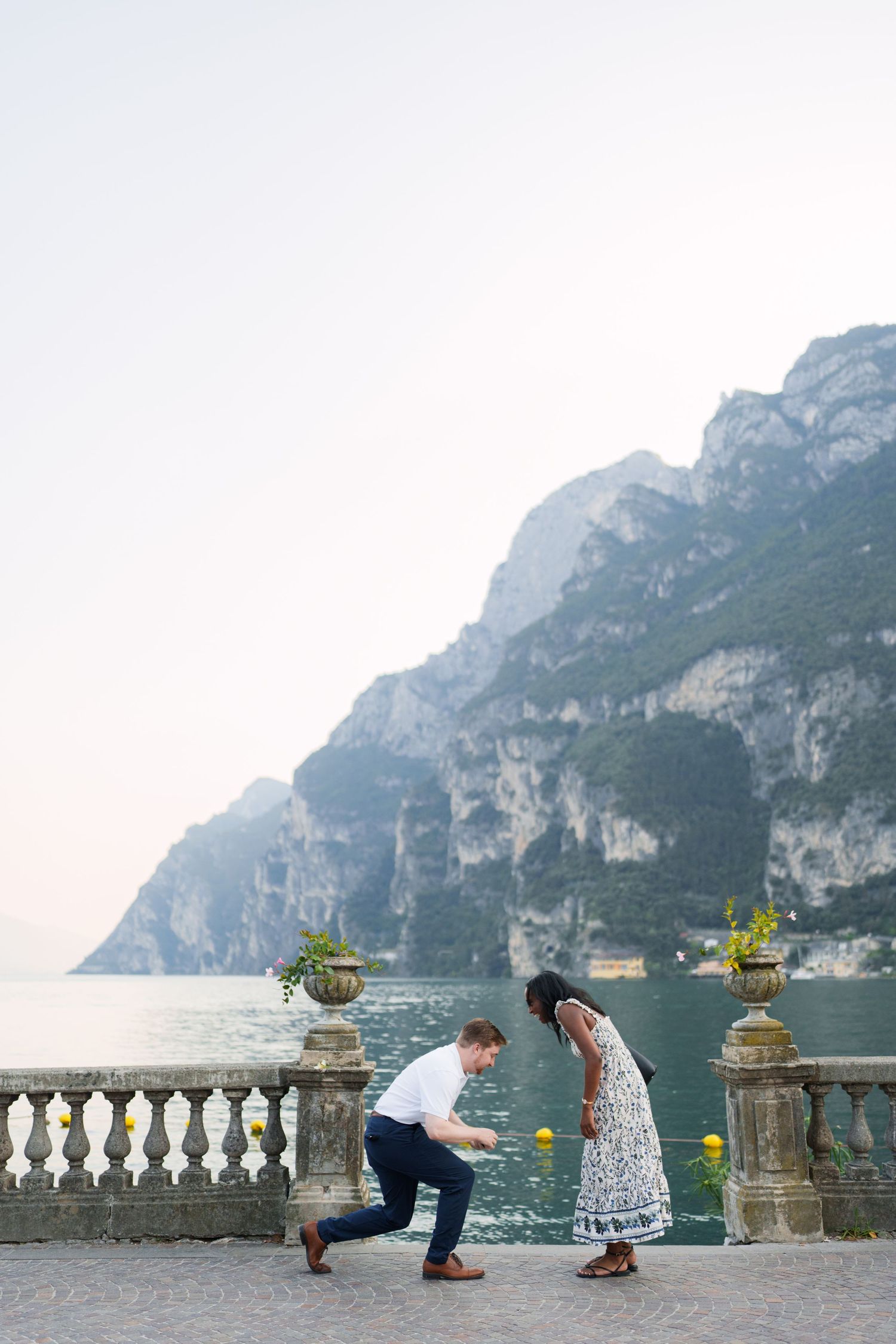 Surprise marriage proposal on one knee overlooking Lake Garda in Riva del Garda, Italy