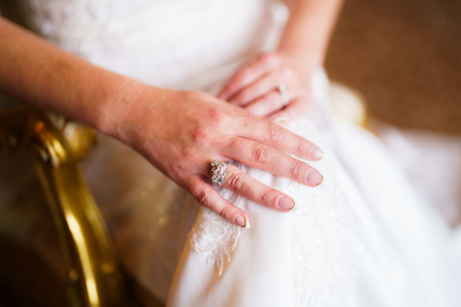 A close-up view of hands kneading and stretching fresh dough on a wooden surface.