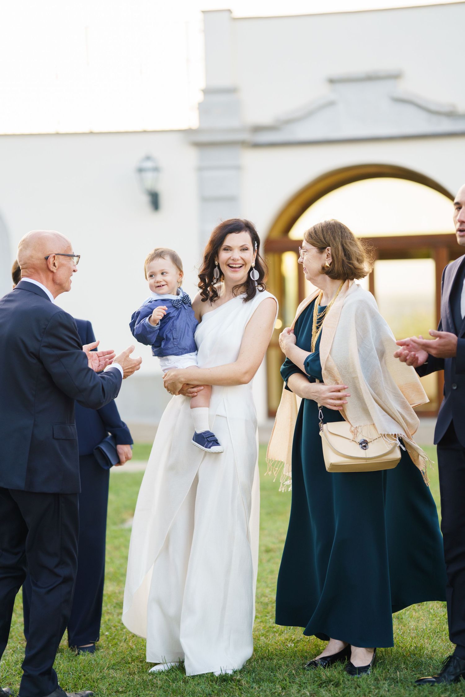 Candid moments of wedding party members interacting outside church after ceremony.