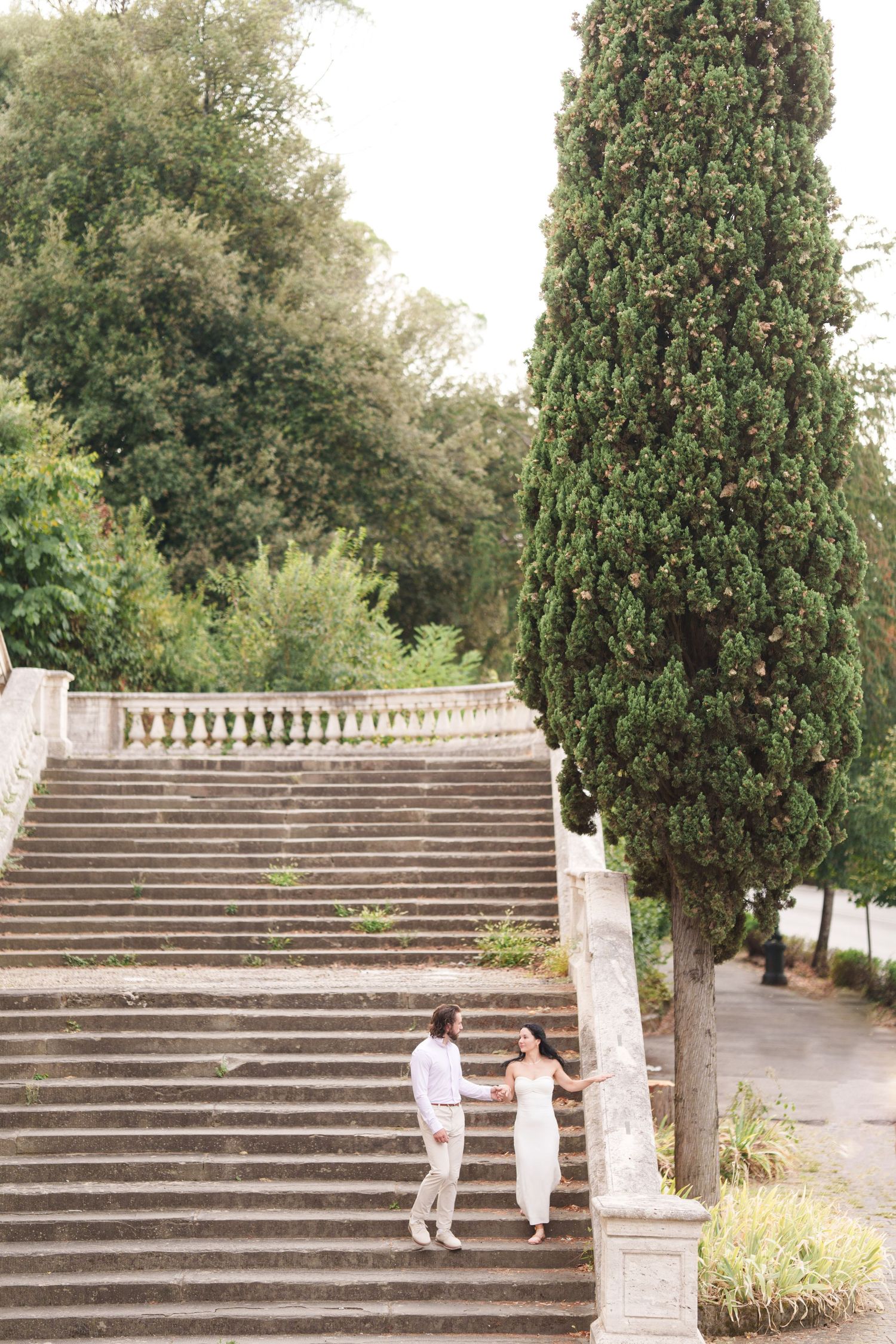 A series of five photos showing a grand outdoor stone staircase with decorative balustrades in a garden setting.