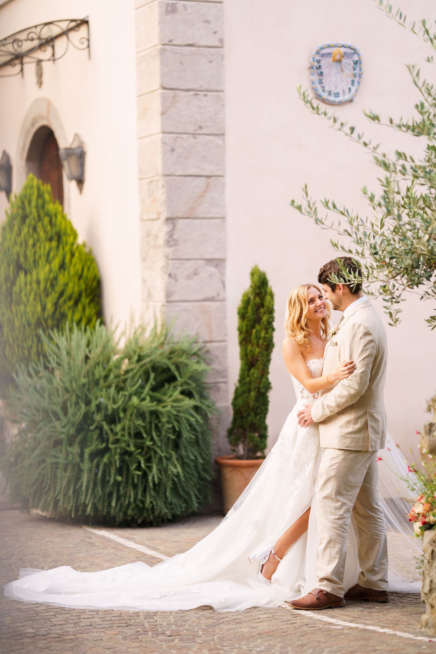 A romantic wedding photoshoot sequence against a Mediterranean-style building exterior.