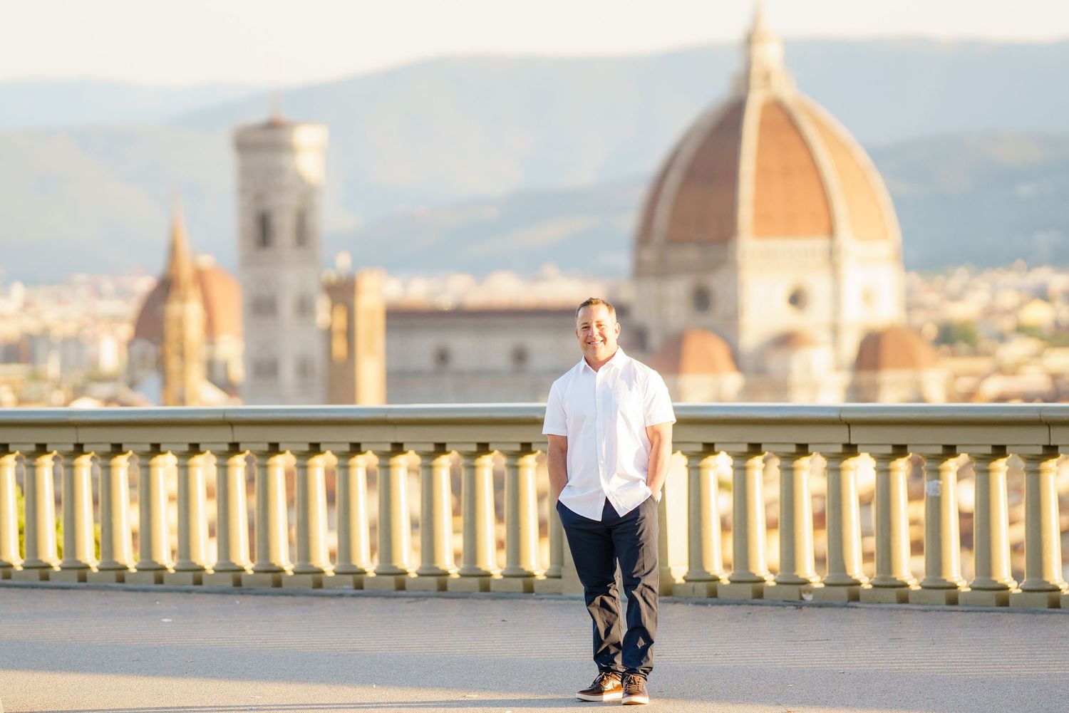 Panoramic view of Florence cityscape with iconic Duomo cathedral and historic architecture during sunset.