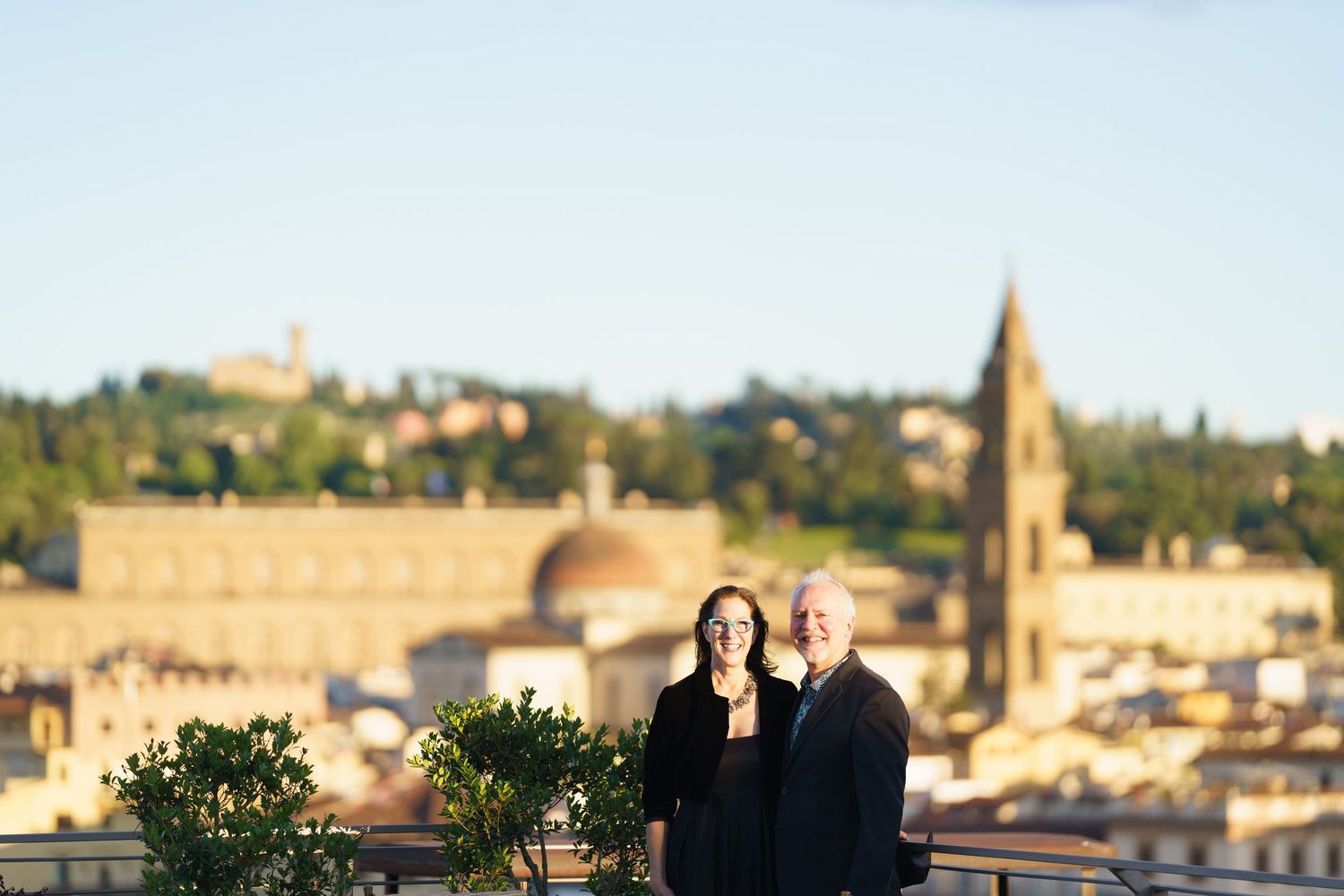 Scenic view of Florence's terracotta rooftops and historic architecture at golden hour.