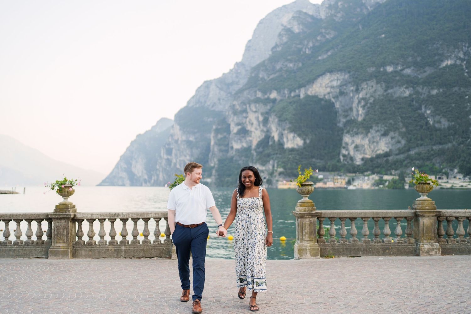 Engaged couple embracing beside Lake Garda during their Riva del Garda proposal session