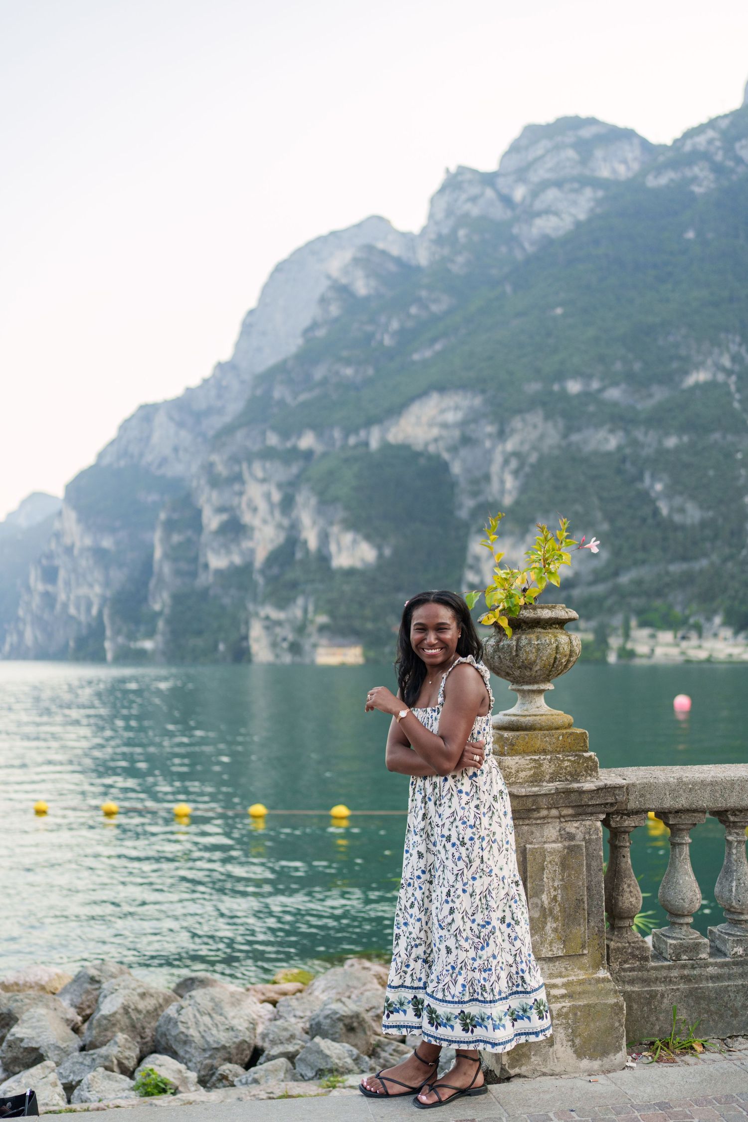 Engaged couple embracing beside Lake Garda during their Riva del Garda proposal session