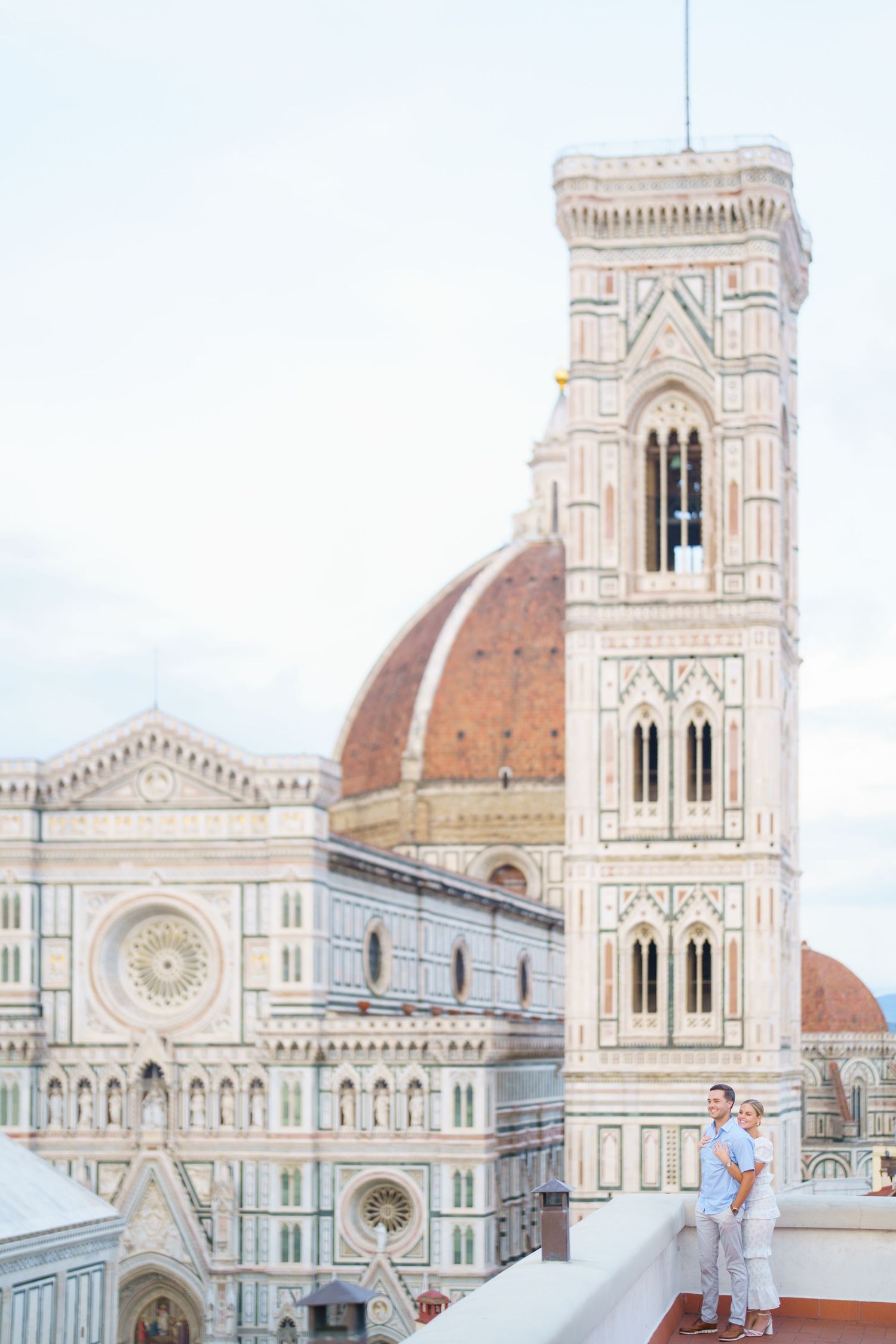 Stunning view of Florence Cathedral's iconic dome and architectural details against a bright blue sky in Italy.