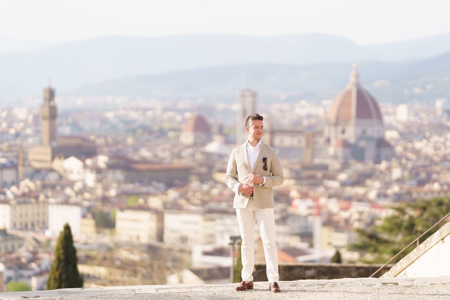 Panoramic view of Florence, Italy with the iconic Duomo cathedral and historic architecture stretching to distant hills.