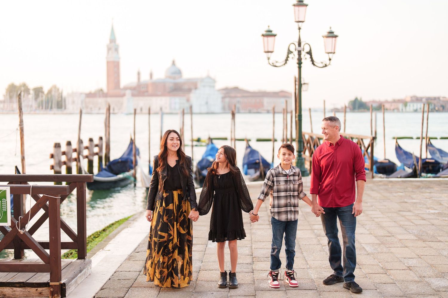 A series of romantic engagement photos taken along Venice's iconic waterfront with gondolas and historic architecture.