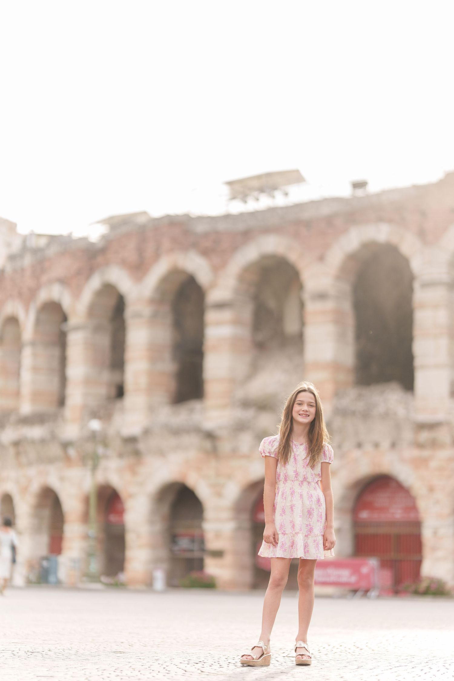 Verona family photographer family walking in front of Verona Arena Italy