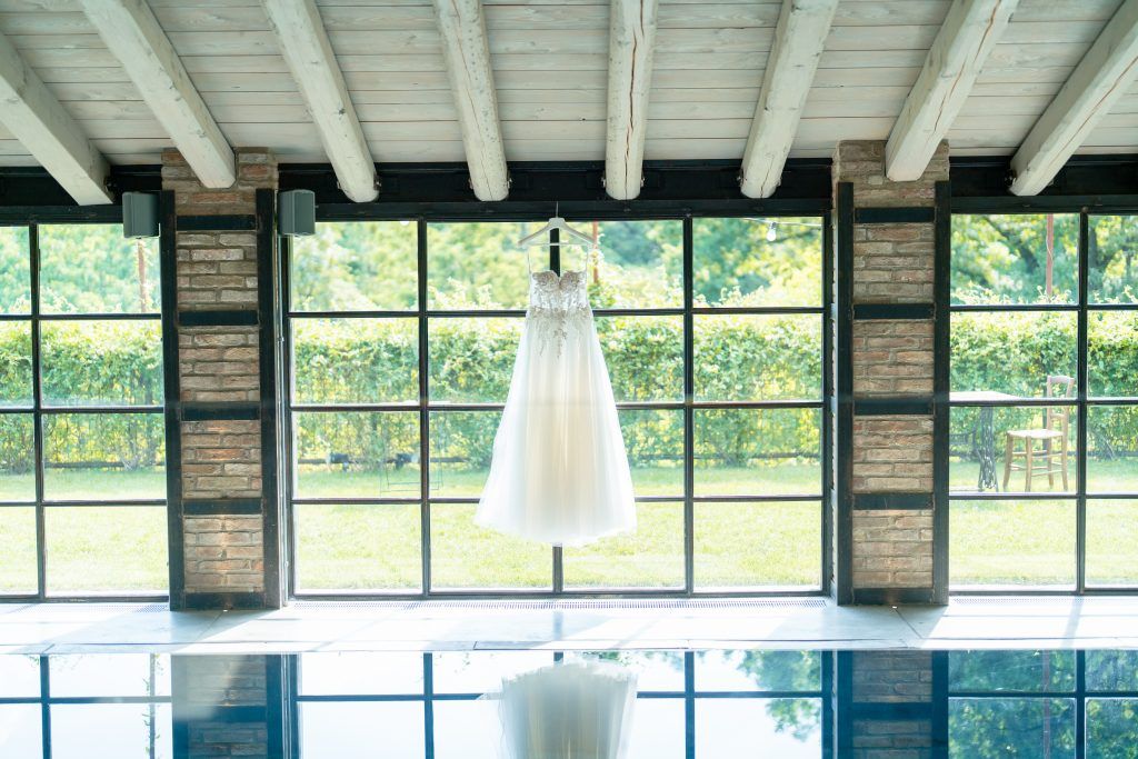 Modern venue interior with exposed wooden beams and large windows overlooking a scenic landscape.