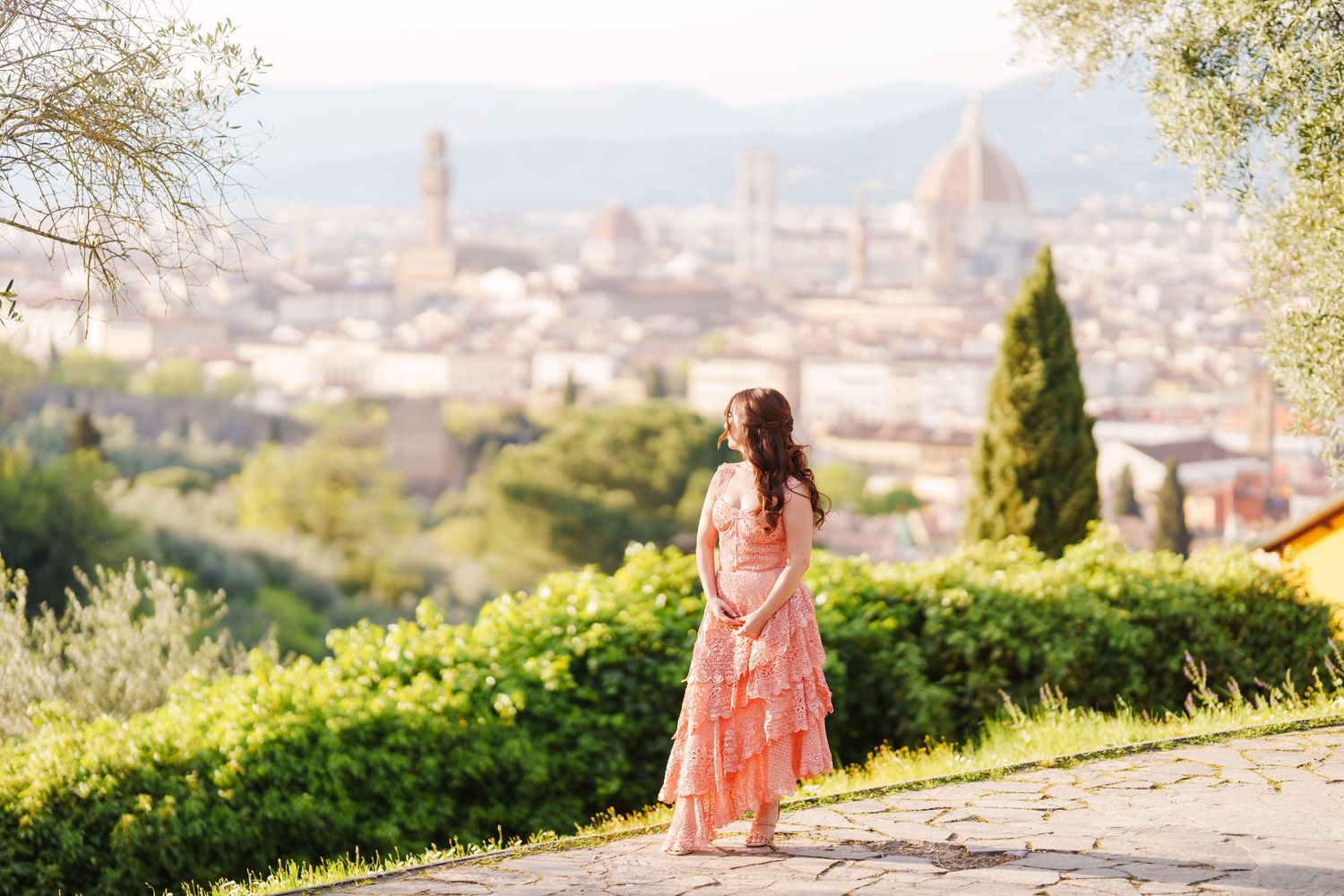 A scenic panoramic view of Florence, Italy with the iconic Duomo cathedral dome visible in the distance.