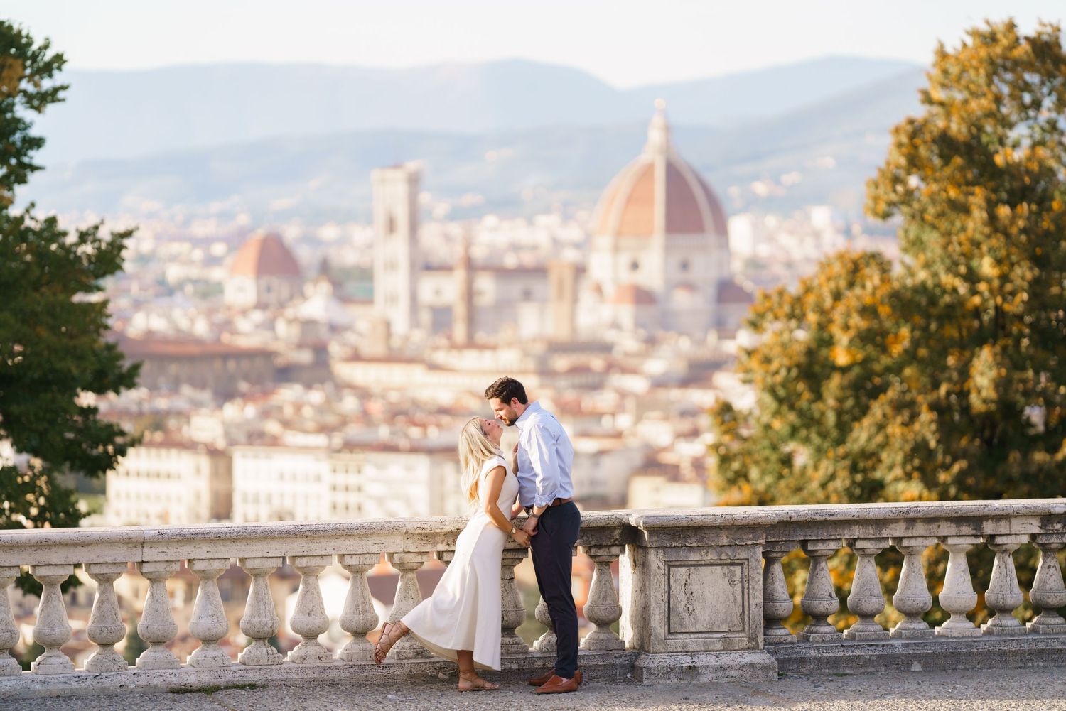A romantic moment overlooking Florence's skyline with the iconic Duomo cathedral visible in the background.