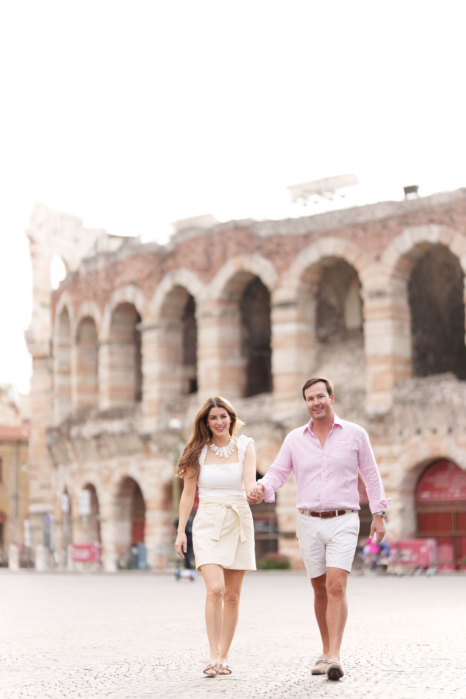 Verona family photographer family walking in front of Verona Arena Italy