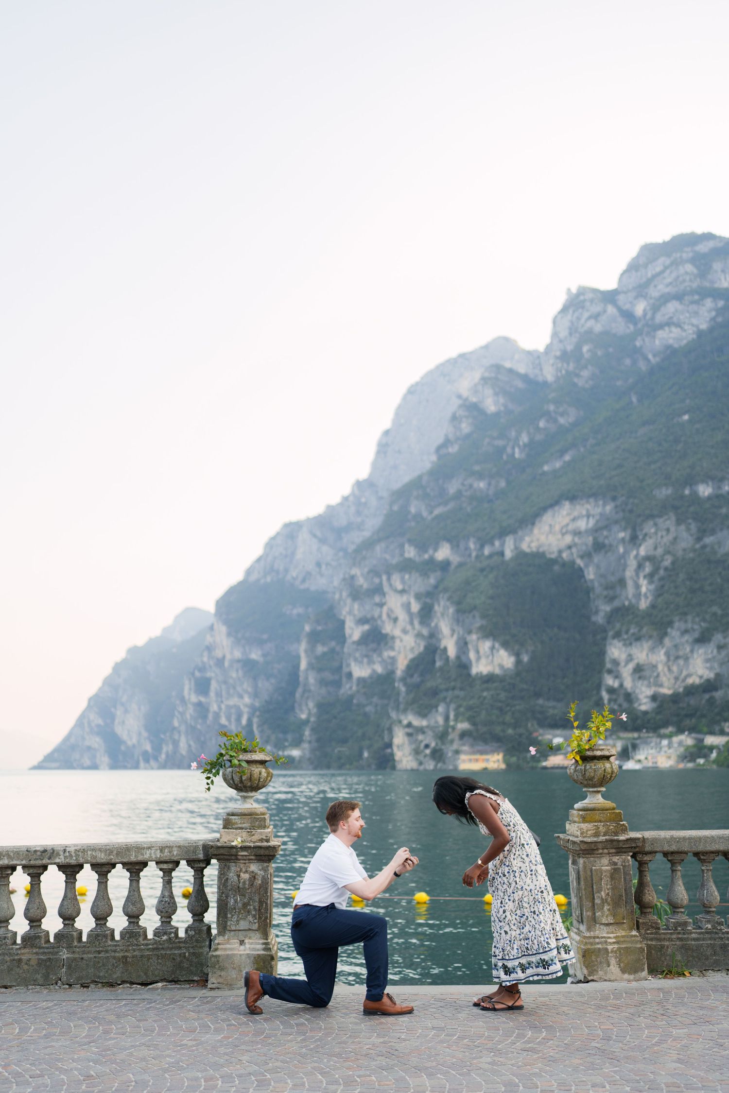 Surprise marriage proposal on one knee overlooking Lake Garda in Riva del Garda, Italy
