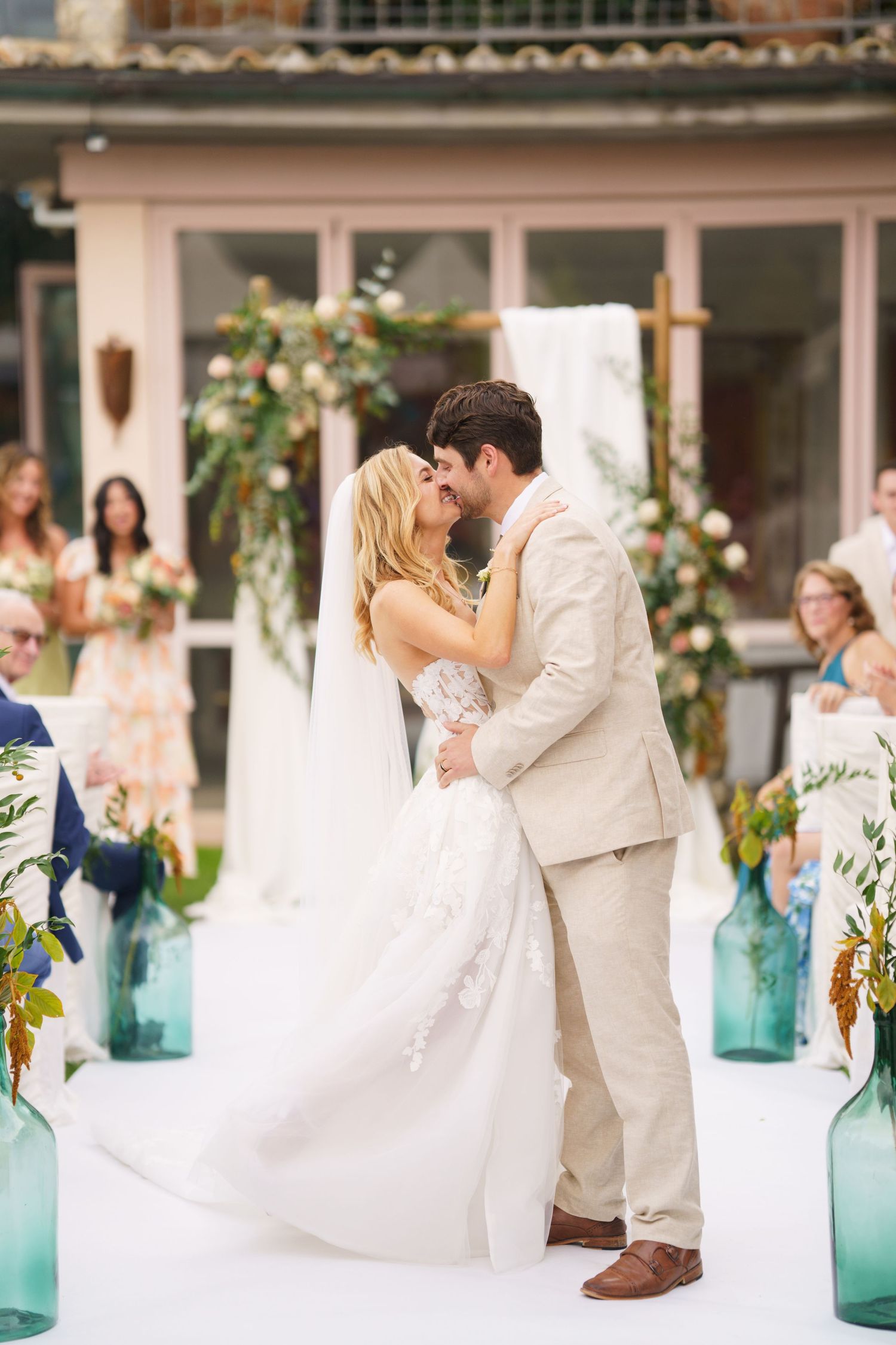 Wedding ceremony moments captured at an elegant venue with turquoise decor accents.