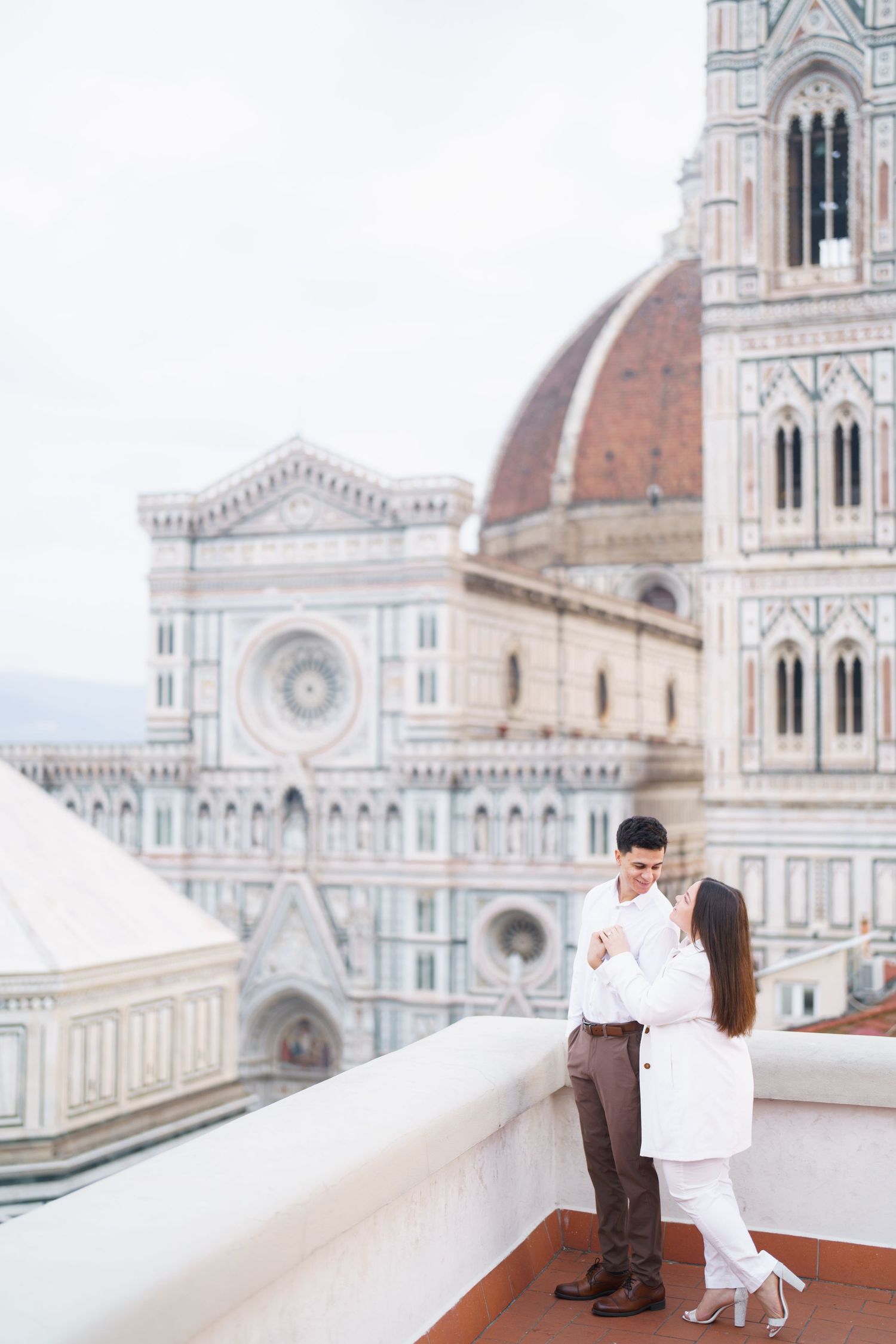 Romantic scene on Florence Cathedral terrace with Duomo and bell tower in background.