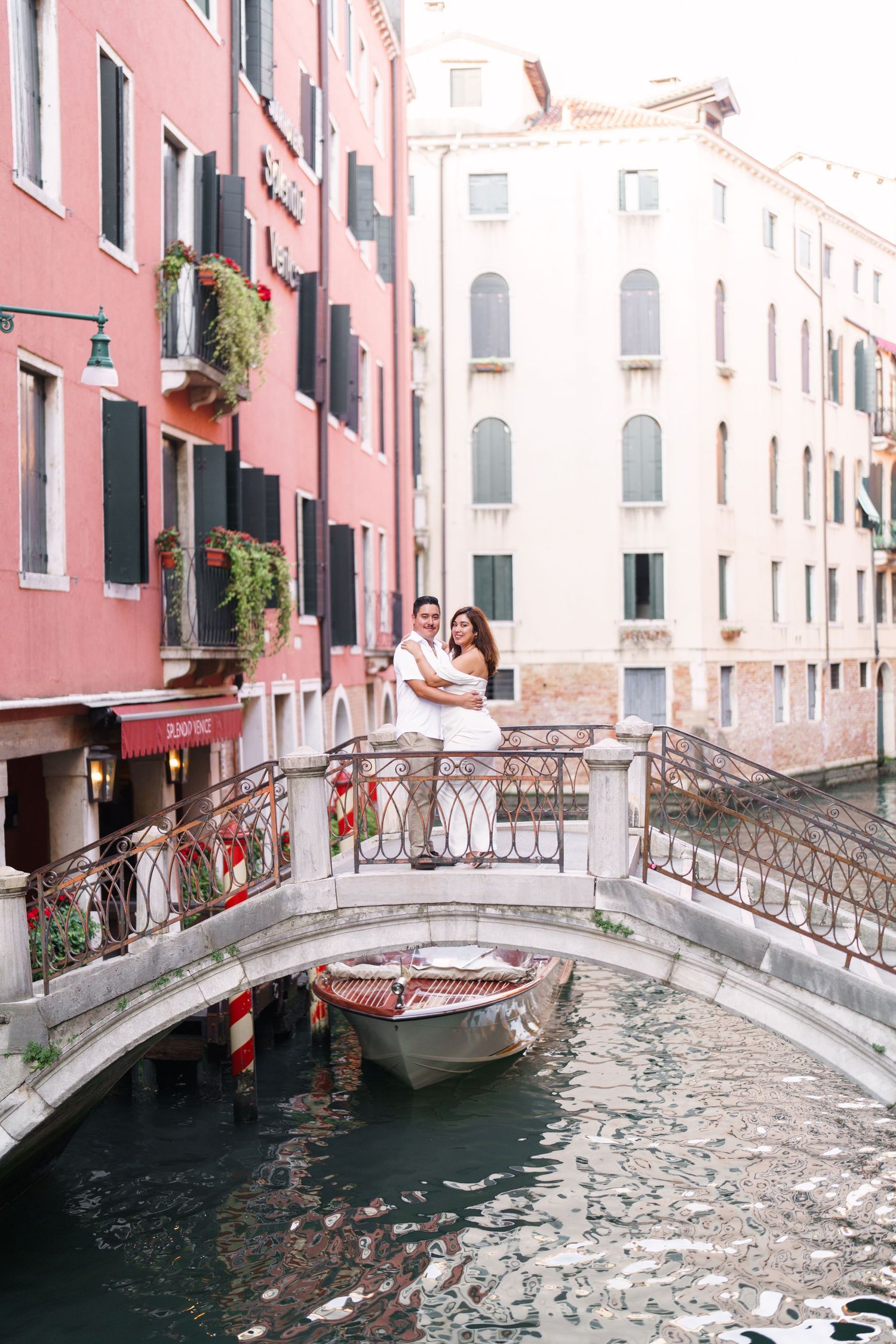 Four connected photos show a charming stone bridge over a narrow Venetian canal with pink buildings and ornate railings.