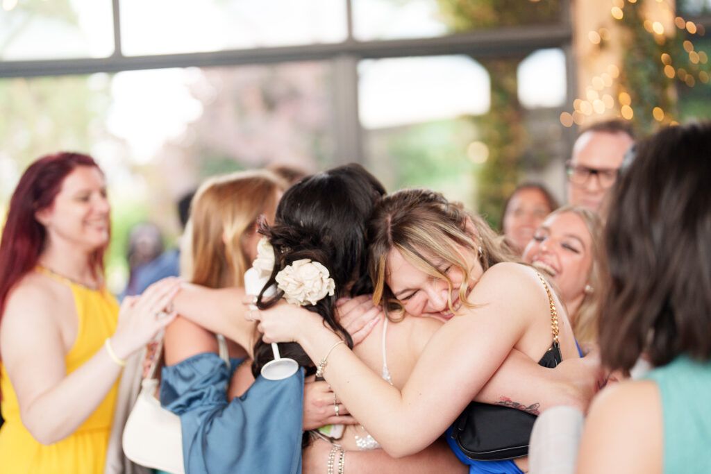 Wedding guests sharing joyful moments during reception celebration.