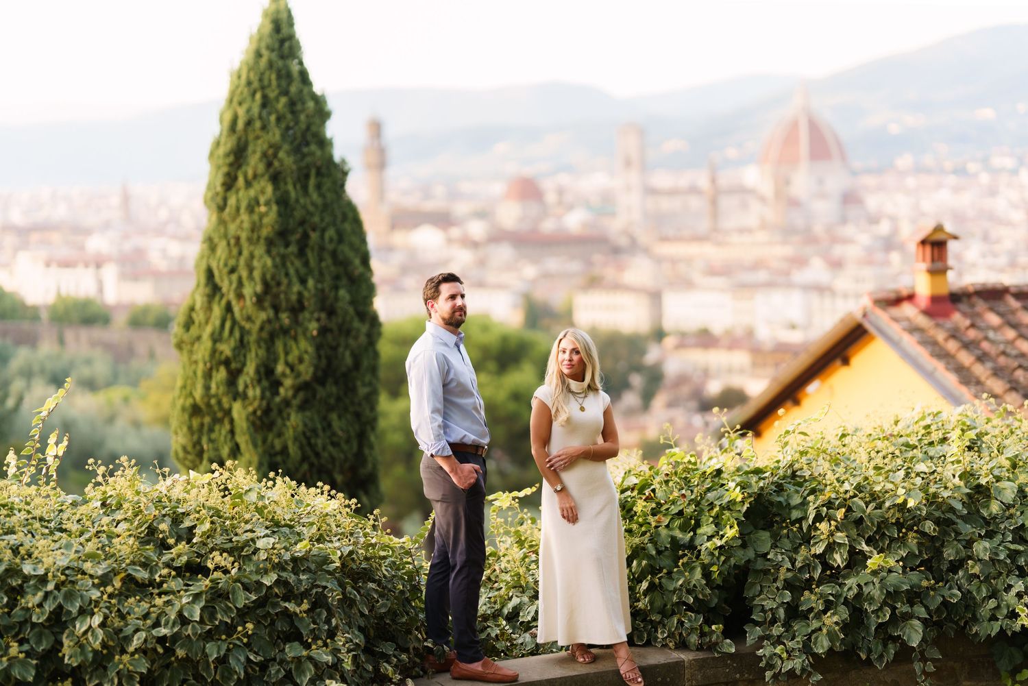 Scenic overlook of Florence Italy with the Duomo cathedral dome visible in the distance on a sunny day.