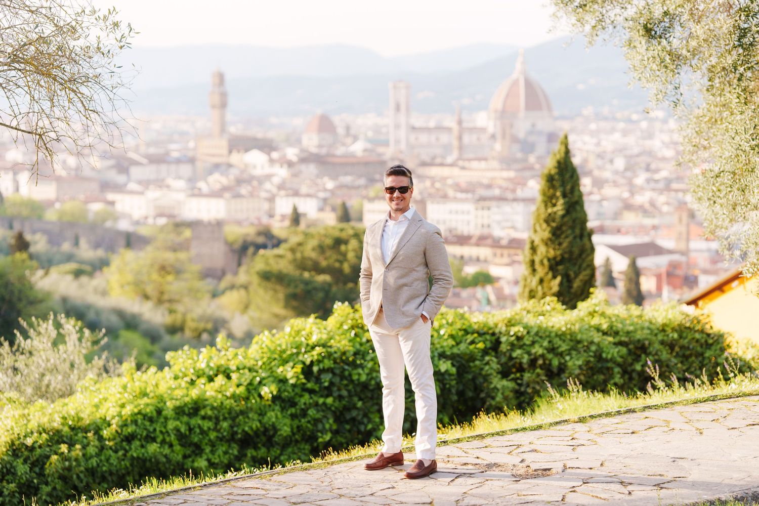 A scenic panoramic view of Florence, Italy with the iconic Duomo cathedral visible in the cityscape at sunset.