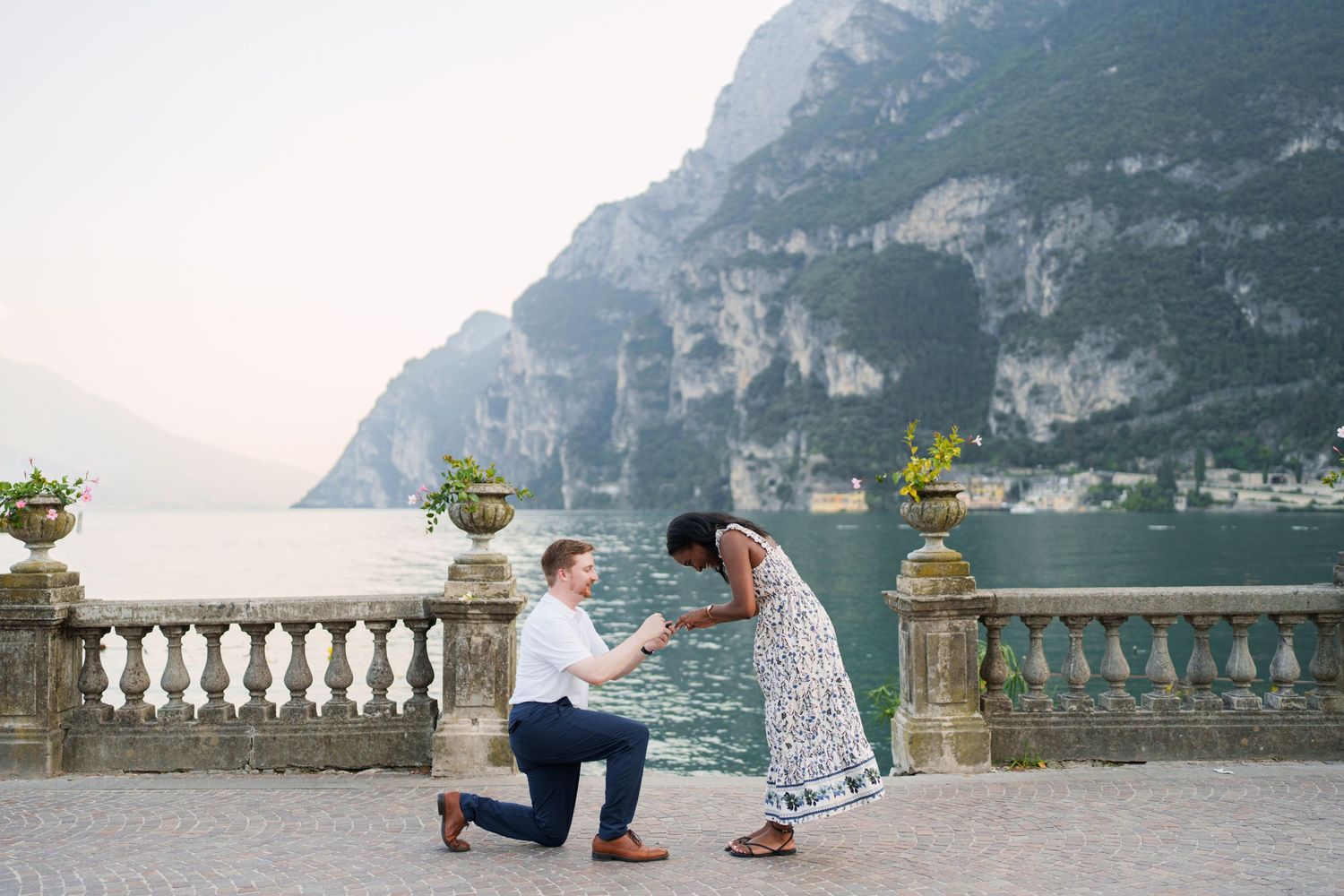 Engaged couple embracing beside Lake Garda during their Riva del Garda proposal session