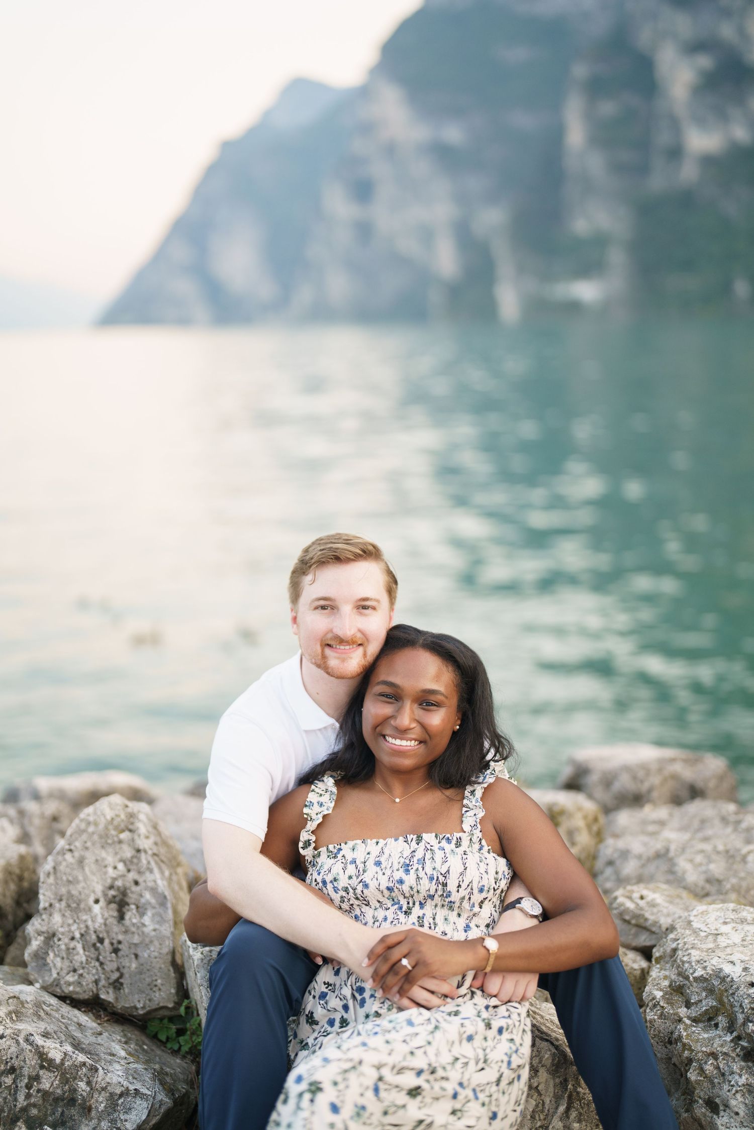 Couple portrait by Lake Garda surrounded by mountains in Riva del Garda, Italy