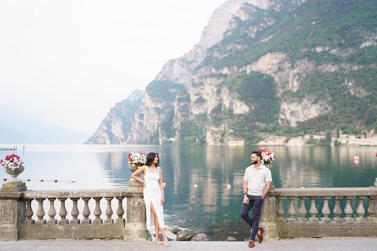 Scenic view of Lake Garda in Italy from a stone balcony terrace with mountains in the background.