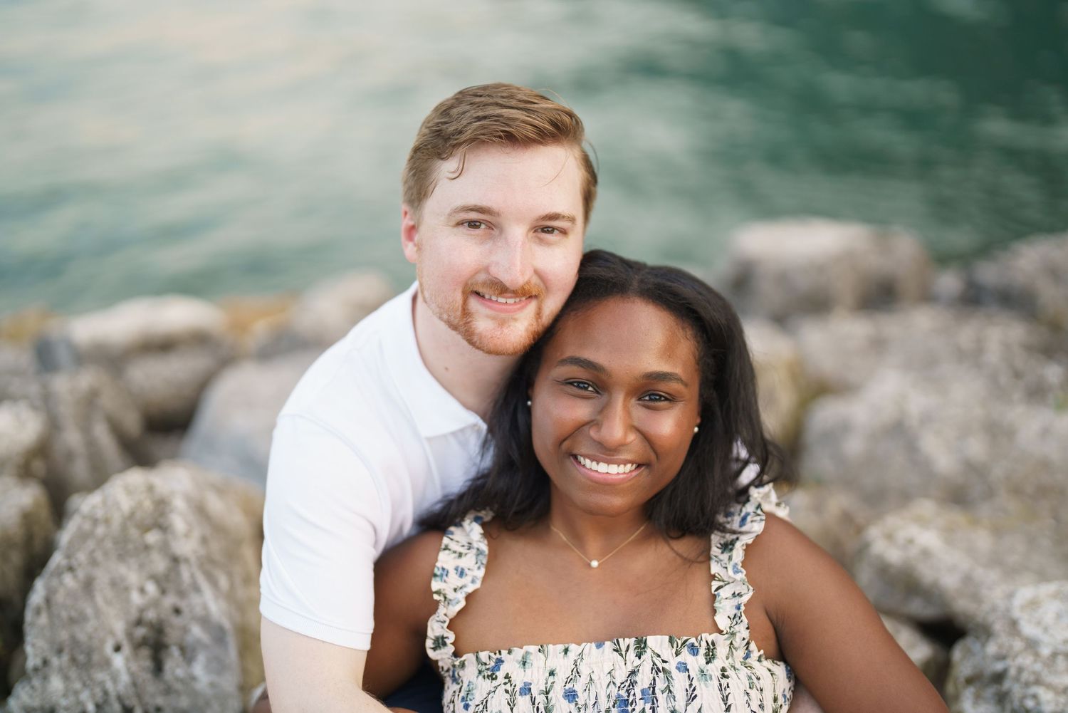 Couple portrait by Lake Garda surrounded by mountains in Riva del Garda, Italy