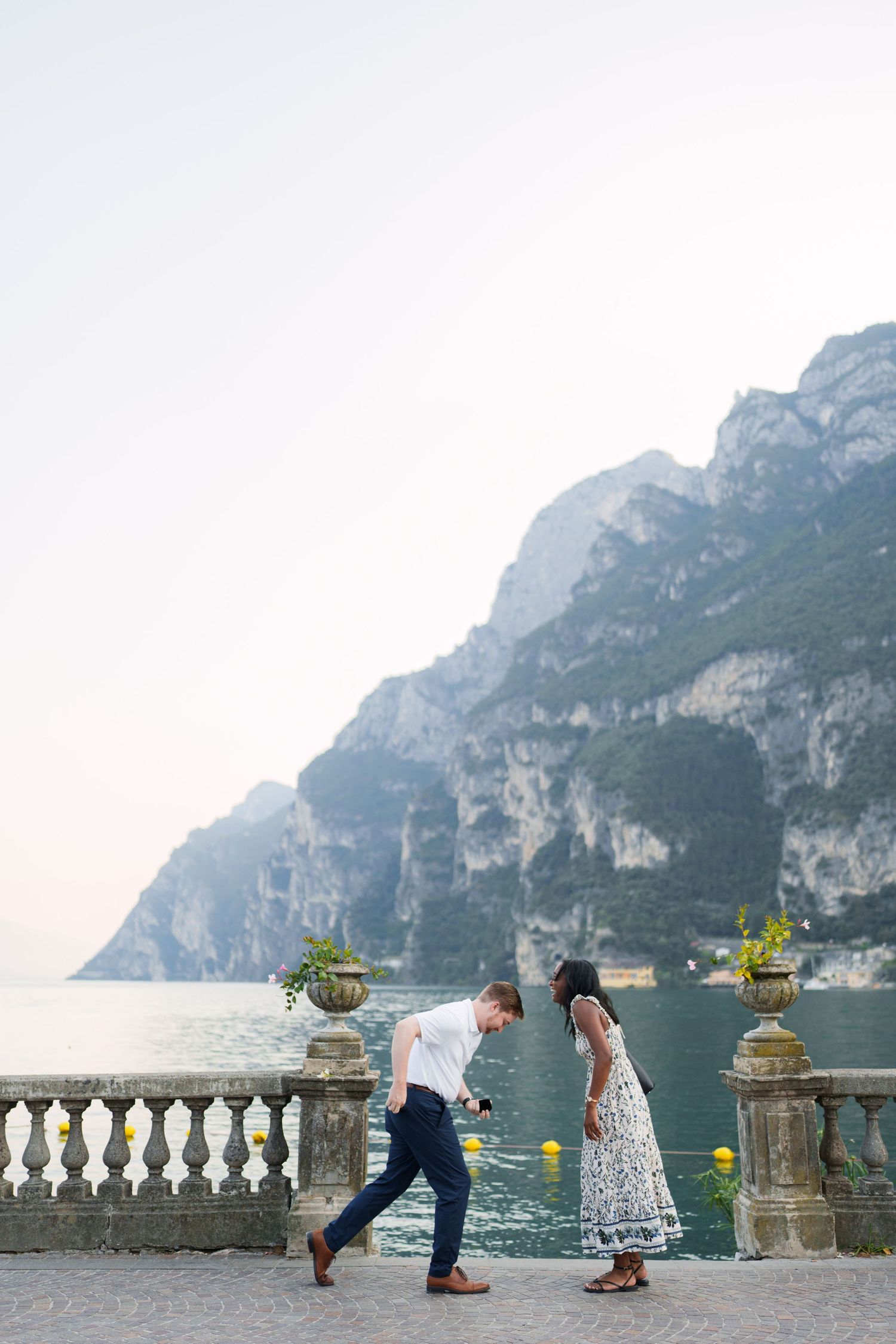 Surprise marriage proposal on one knee overlooking Lake Garda in Riva del Garda, Italy
