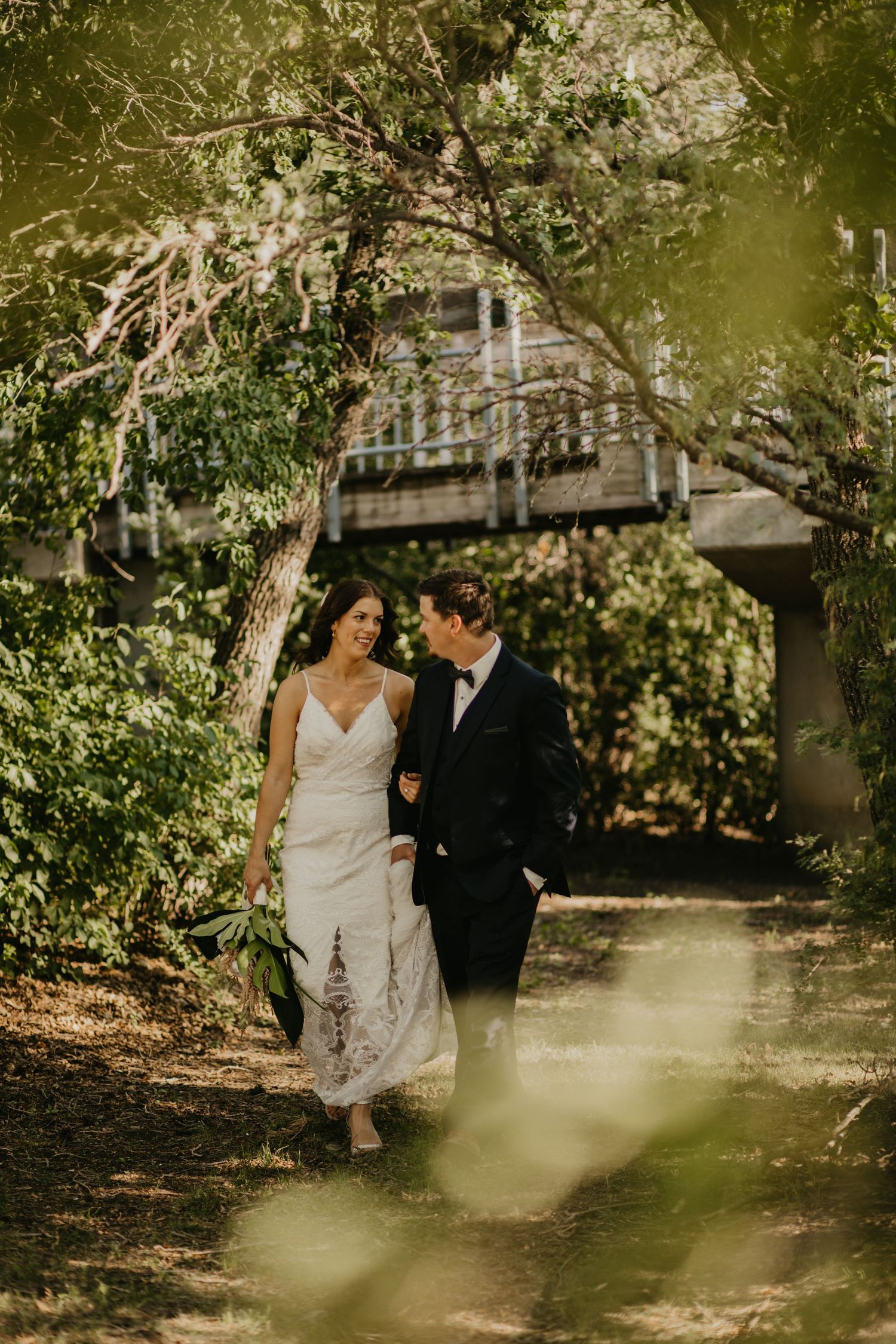 Romantic walk along a garden path with wooden structure visible through the trees.
