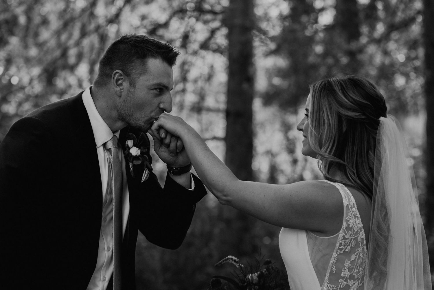 Intimate black and white wedding portrait captured during an emotional moment.