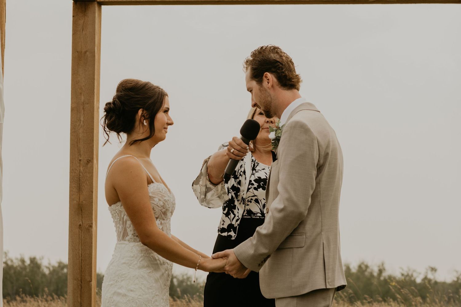 Intimate outdoor wedding ceremony with couple exchanging vows.