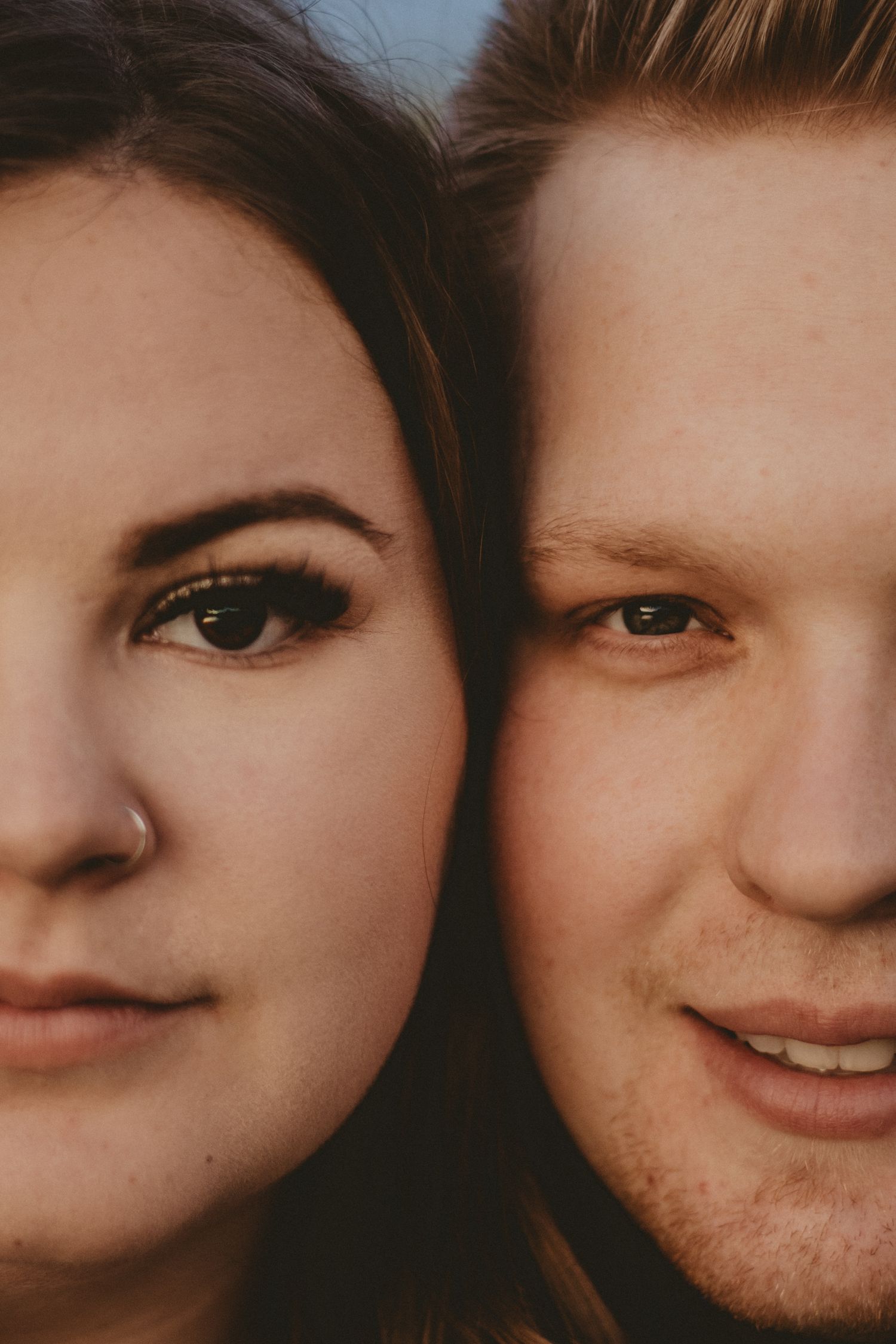 Extreme close-up portrait showing half faces of a couple.