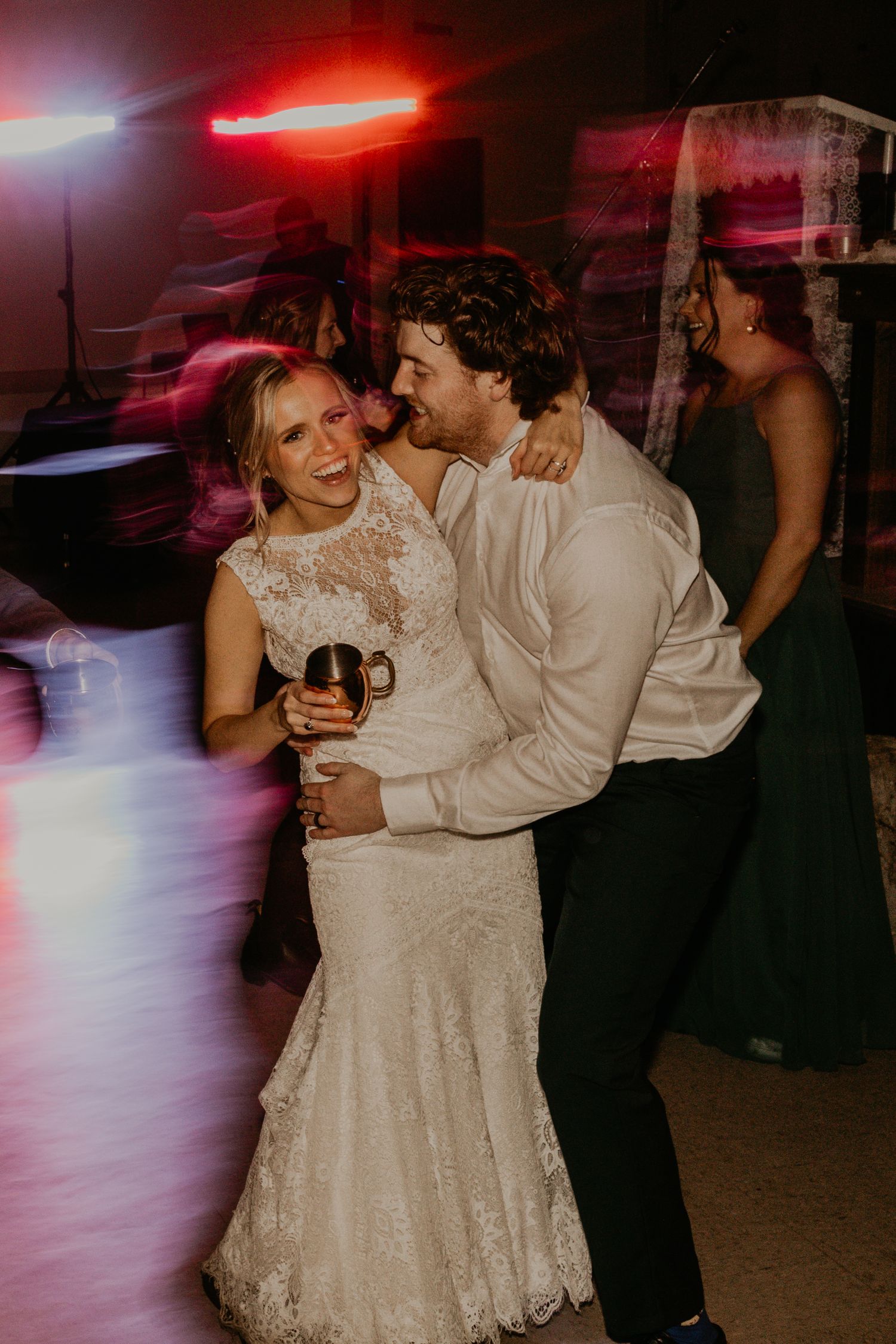 Newlyweds sharing an intimate moment while dancing at their wedding reception.
