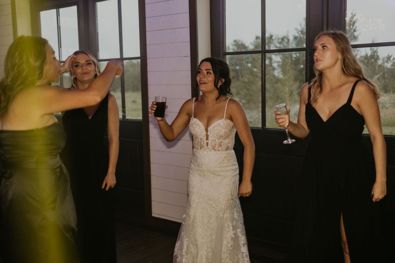 Wedding celebration with guests in formal attire enjoying drinks and conversation.