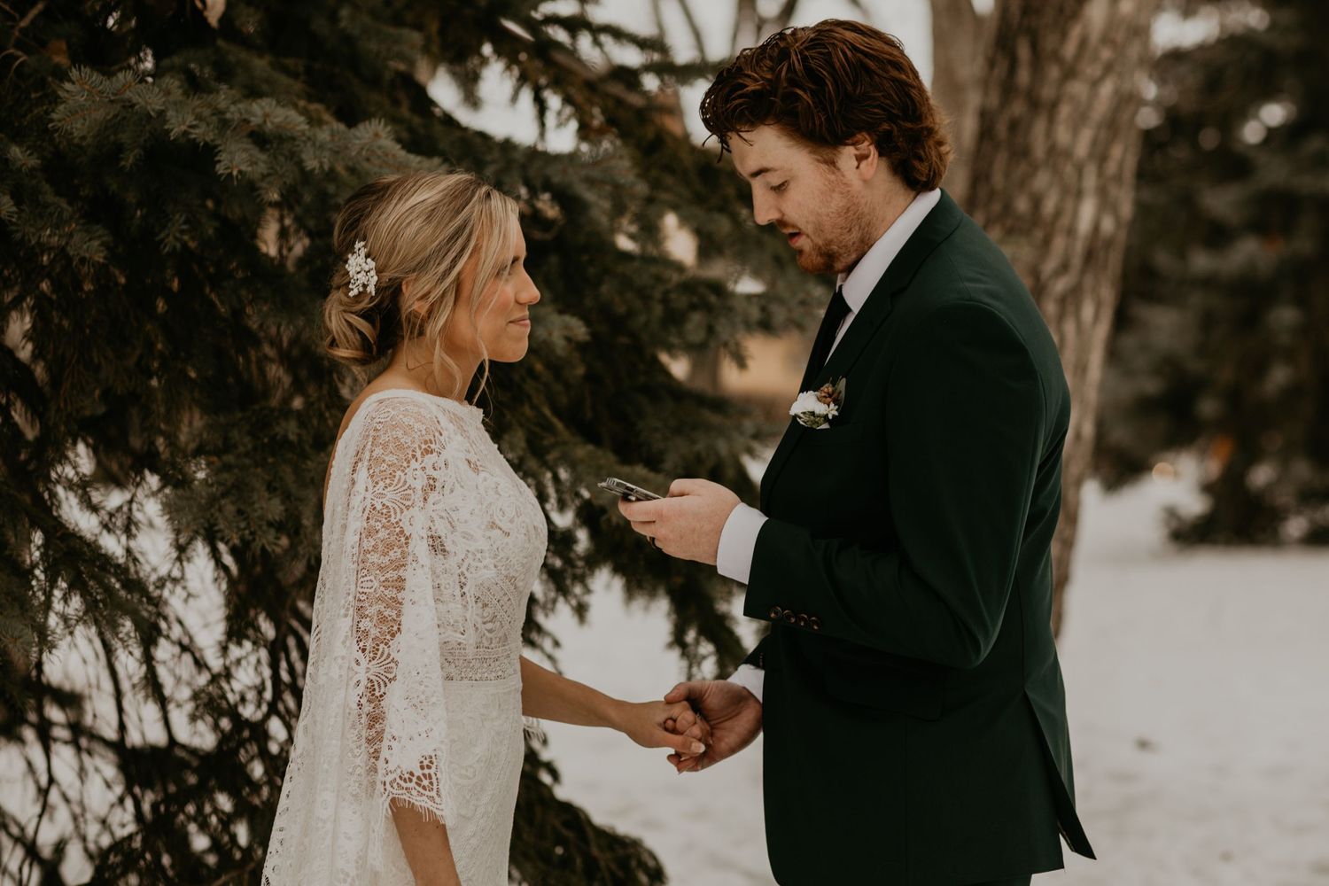A couple shares an intimate moment during their winter wedding ceremony.