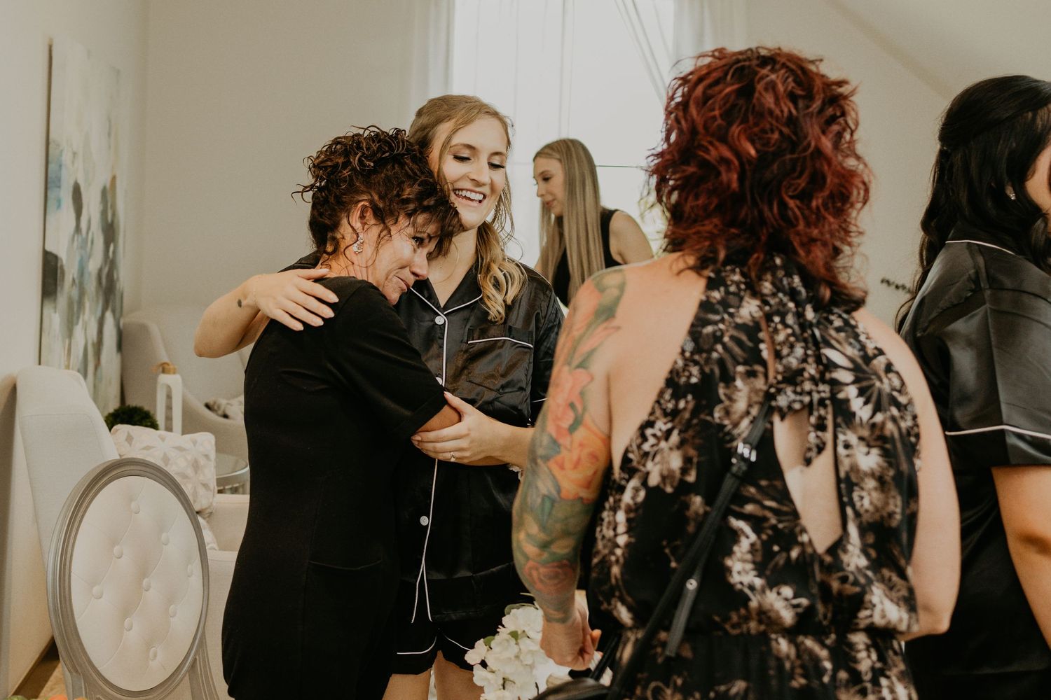 Wedding party members sharing an emotional moment during preparation.