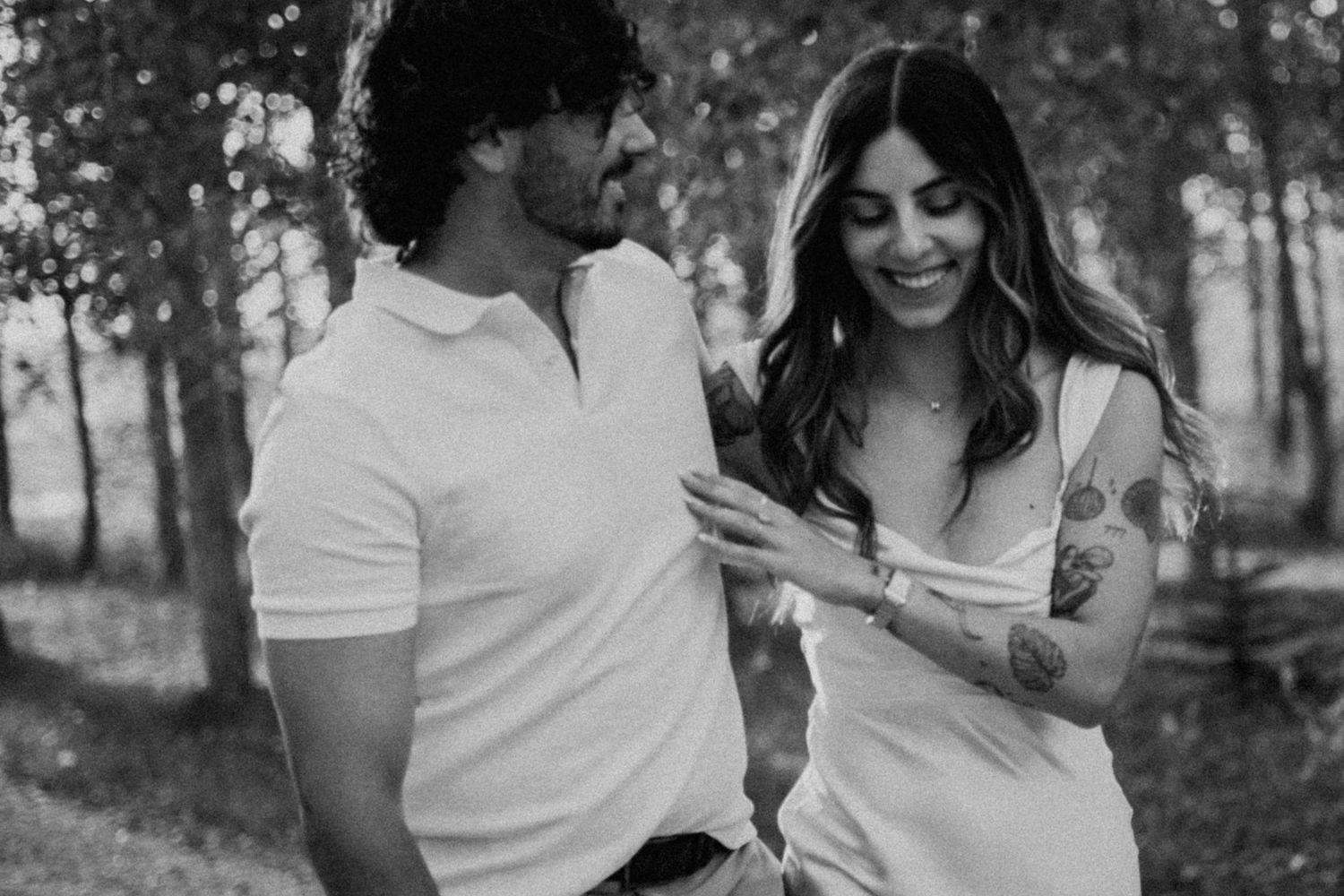 Black and white photo collection of a couple embracing and laughing together outdoors in a romantic photoshoot.