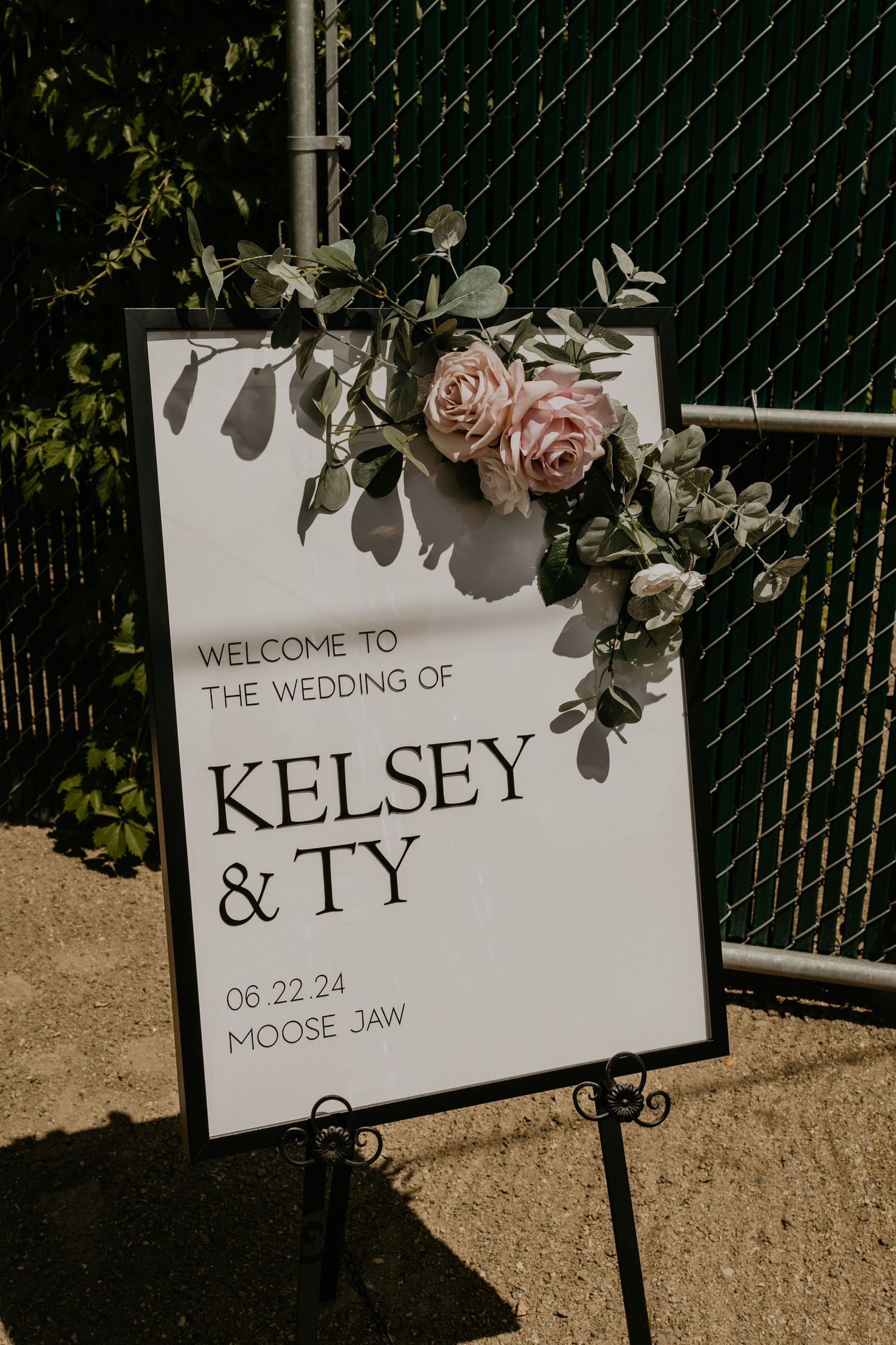 Wedding welcome sign with pink roses and eucalyptus for Kelsey & Ty's celebration in Moose Jaw.