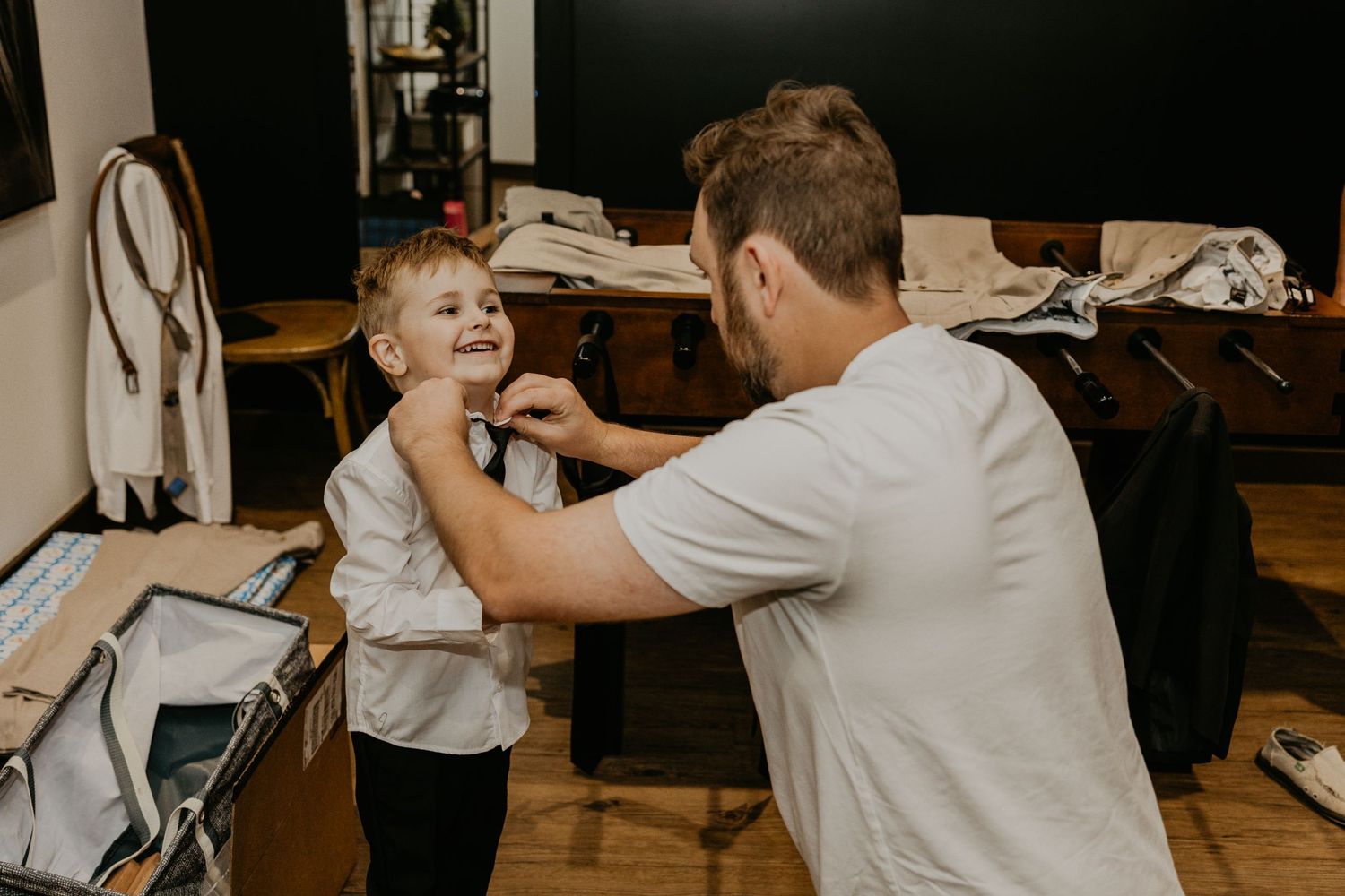 A tender moment during wedding day preparations in a rustic room.