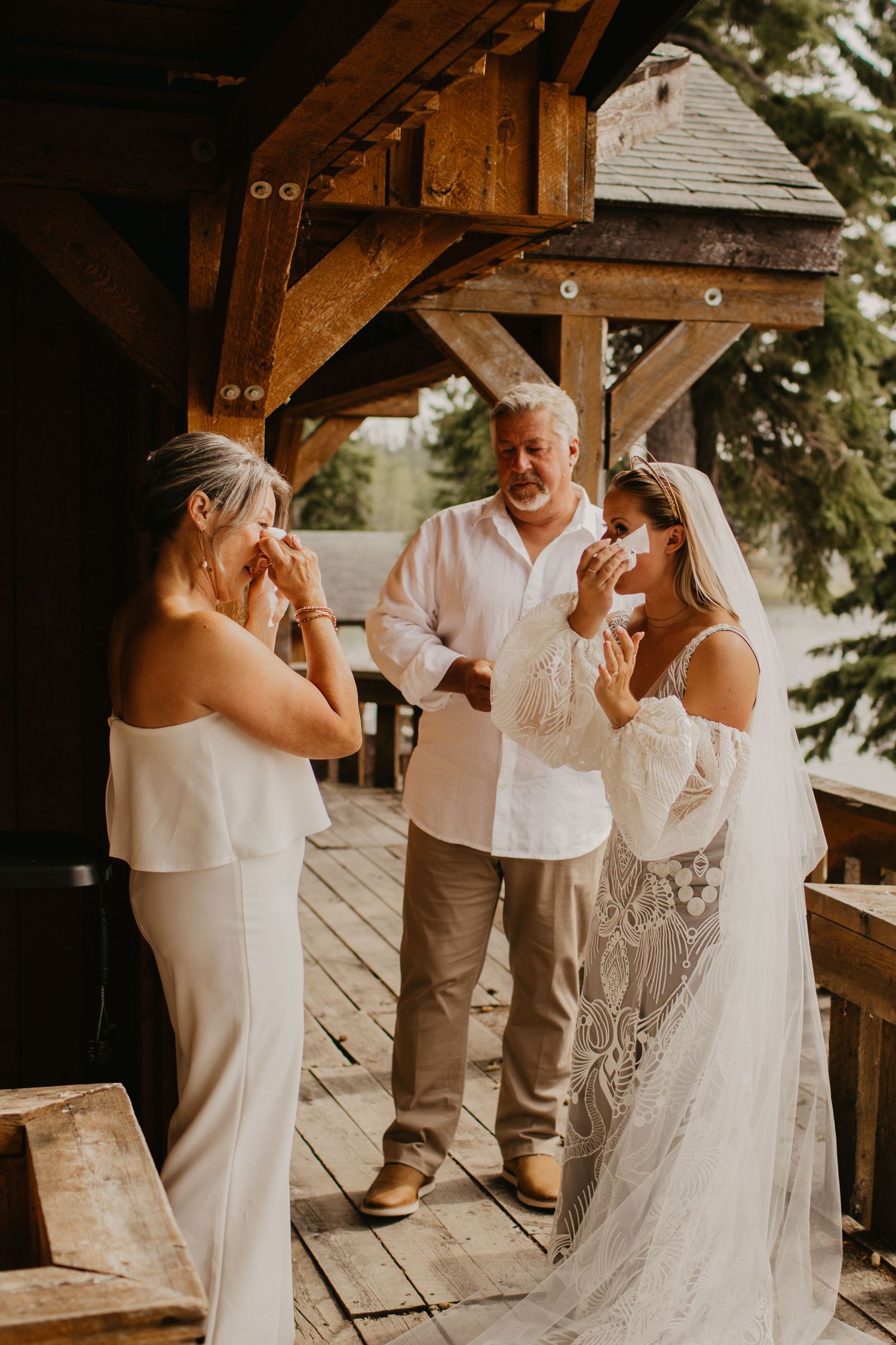 Emotional wedding moment shared on rustic cabin deck.