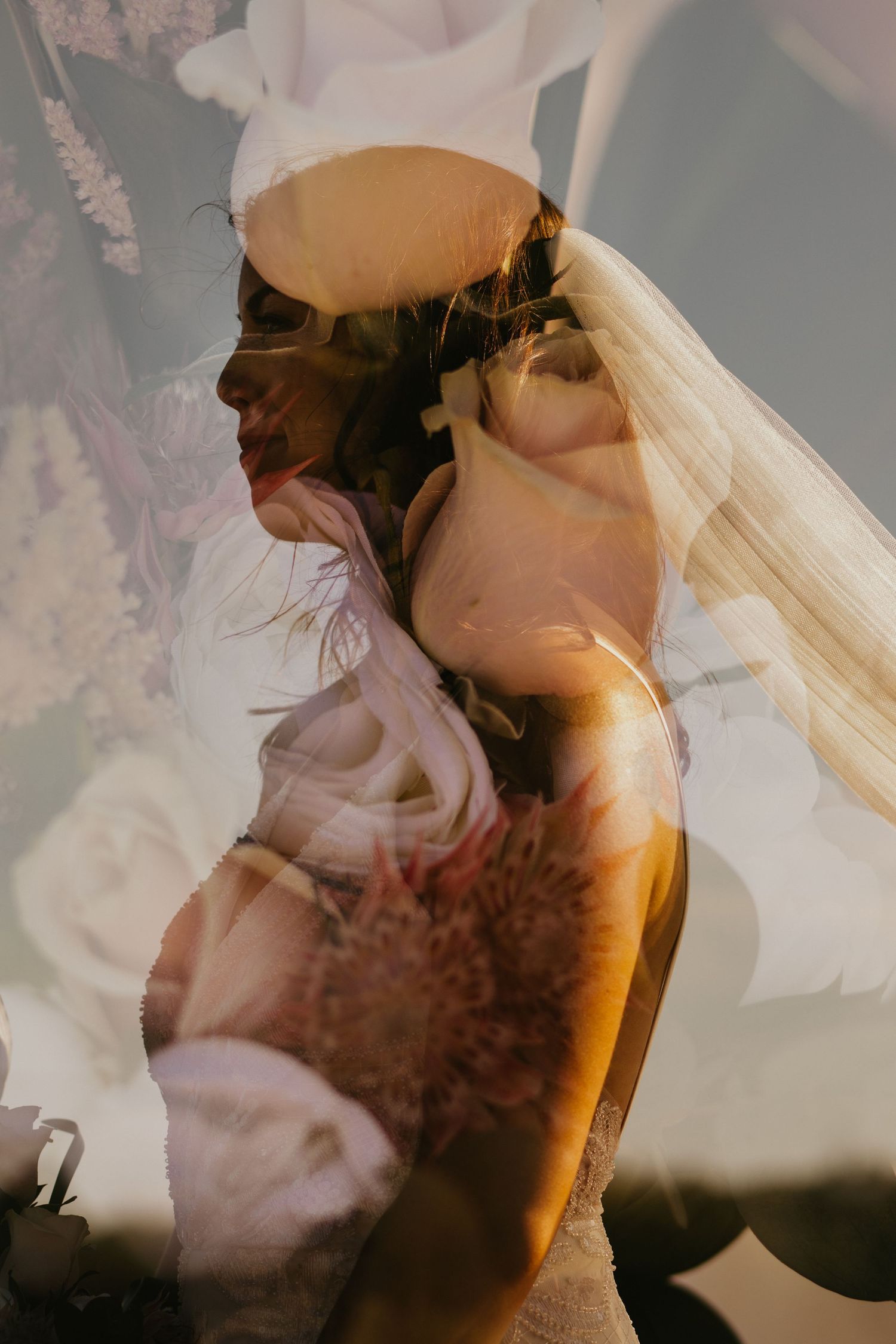 Double exposure wedding photo overlaying bride in white dress and veil with dreamy light effects.