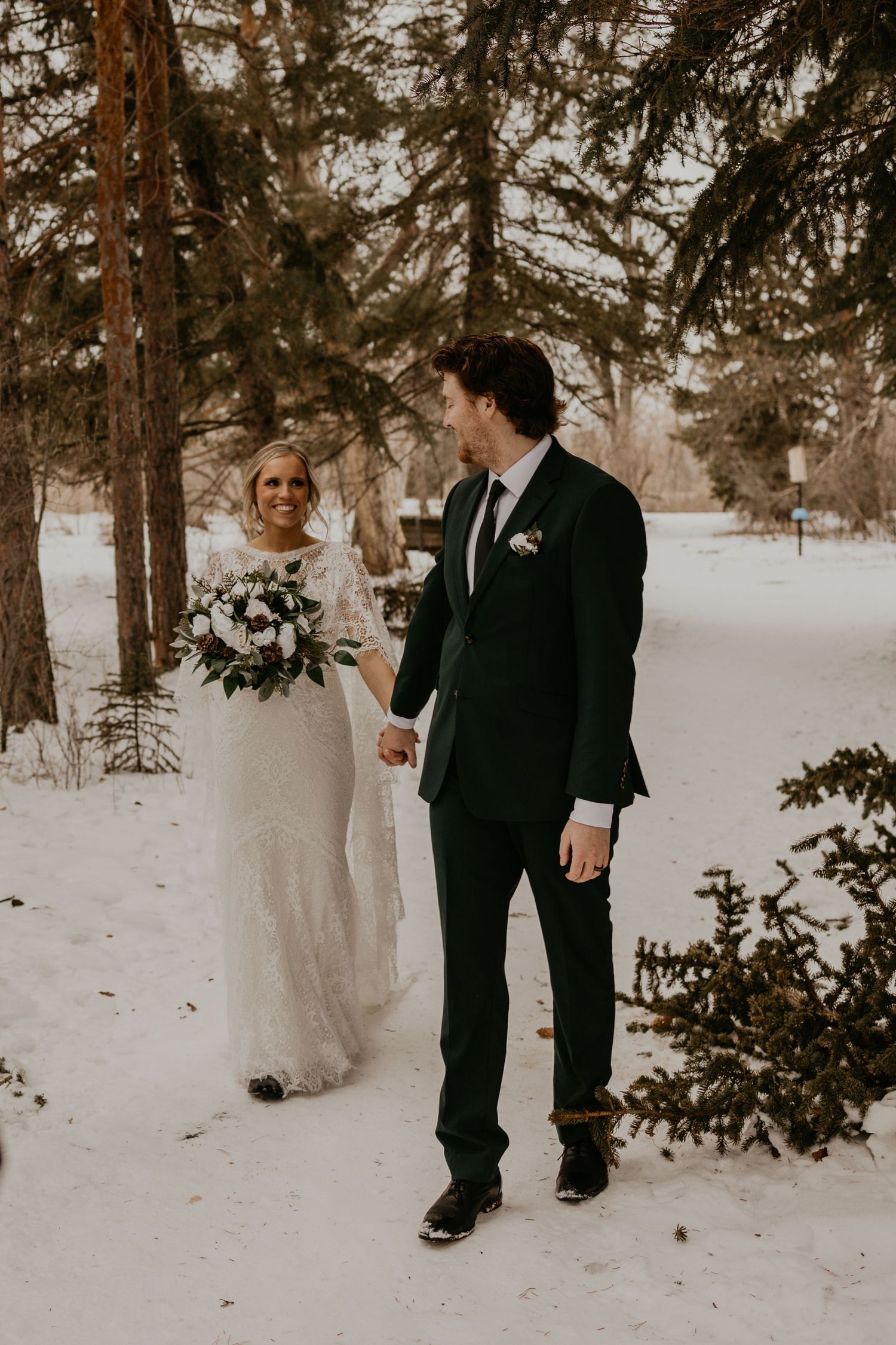 A couple shares a joyful moment during their winter wedding photoshoot.