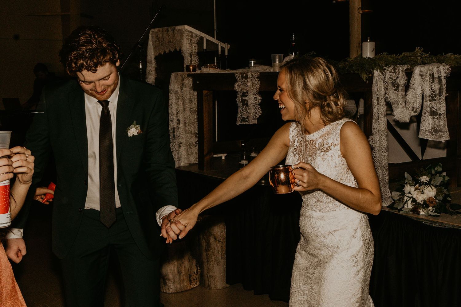 Couple dances together during lively wedding reception celebration.