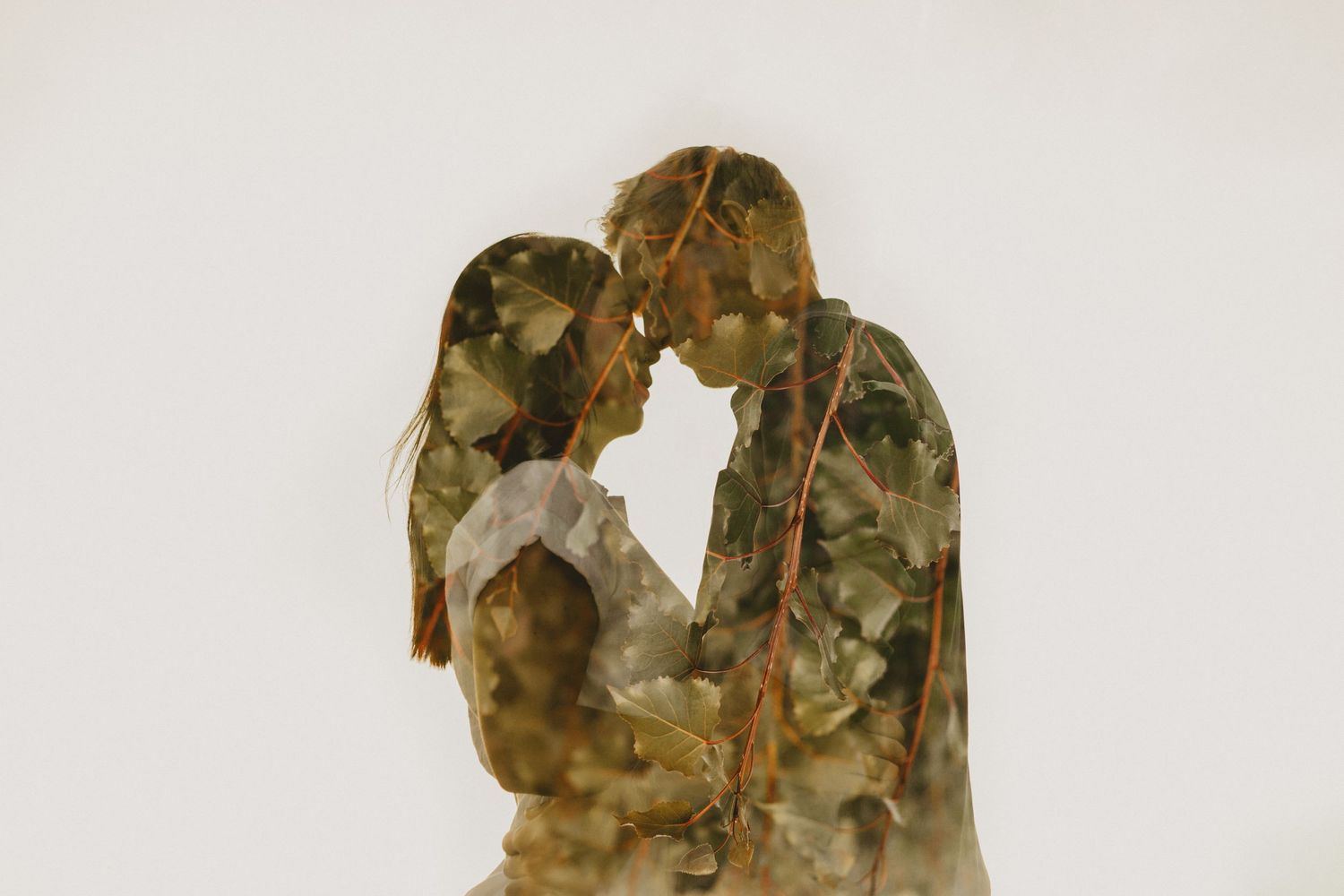 A double exposure silhouette of a couple in military uniforms creating a heart shape.