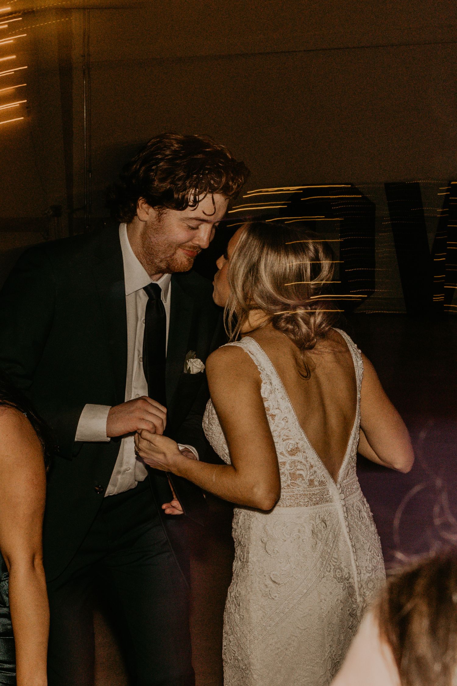 Couple sharing an intimate moment on the dance floor at wedding reception.