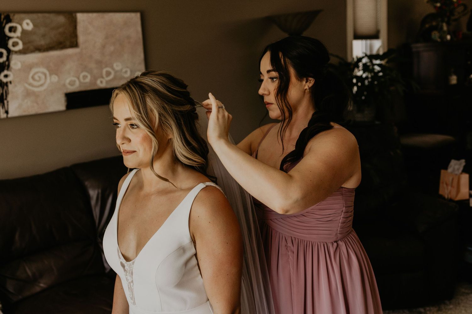 Final wedding preparations taking place in a cozy indoor setting.