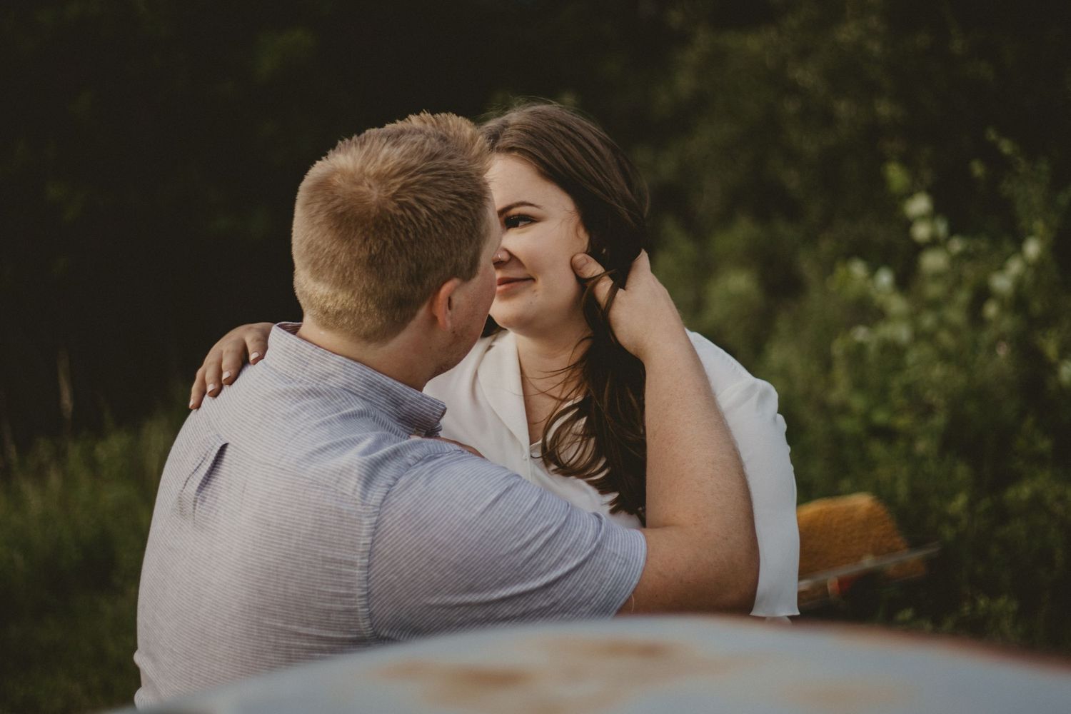 An intimate moment captured between a couple during their outdoor photoshoot.