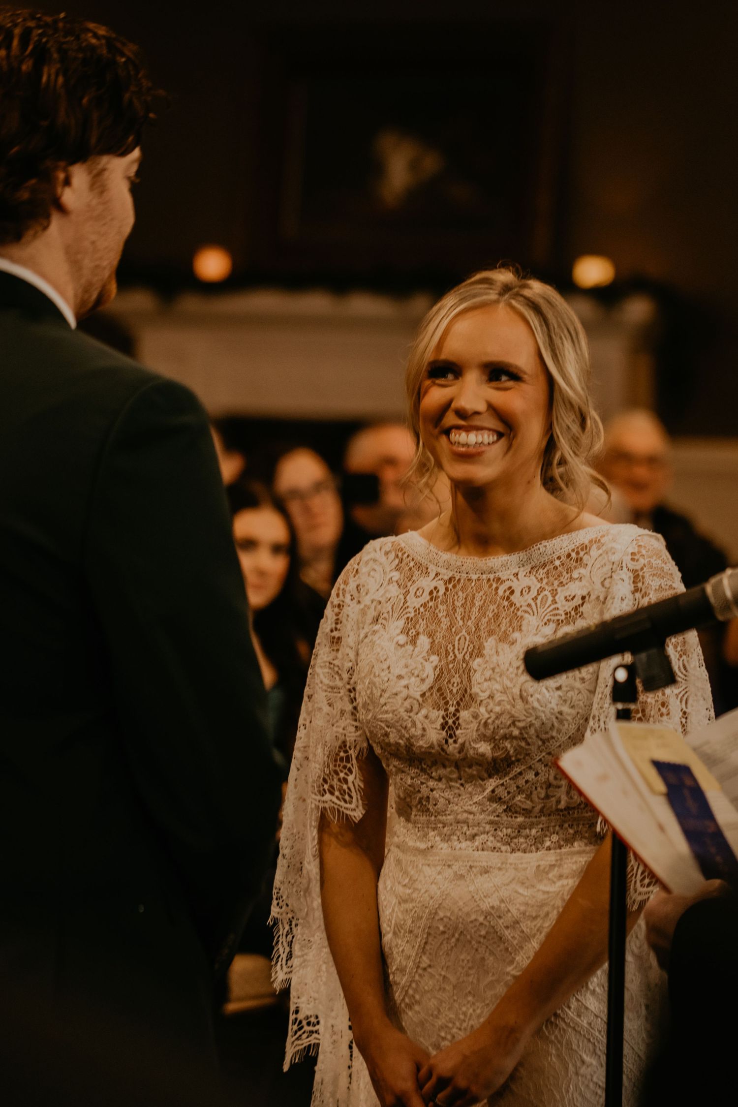Couple exchanges vows during intimate indoor wedding ceremony.